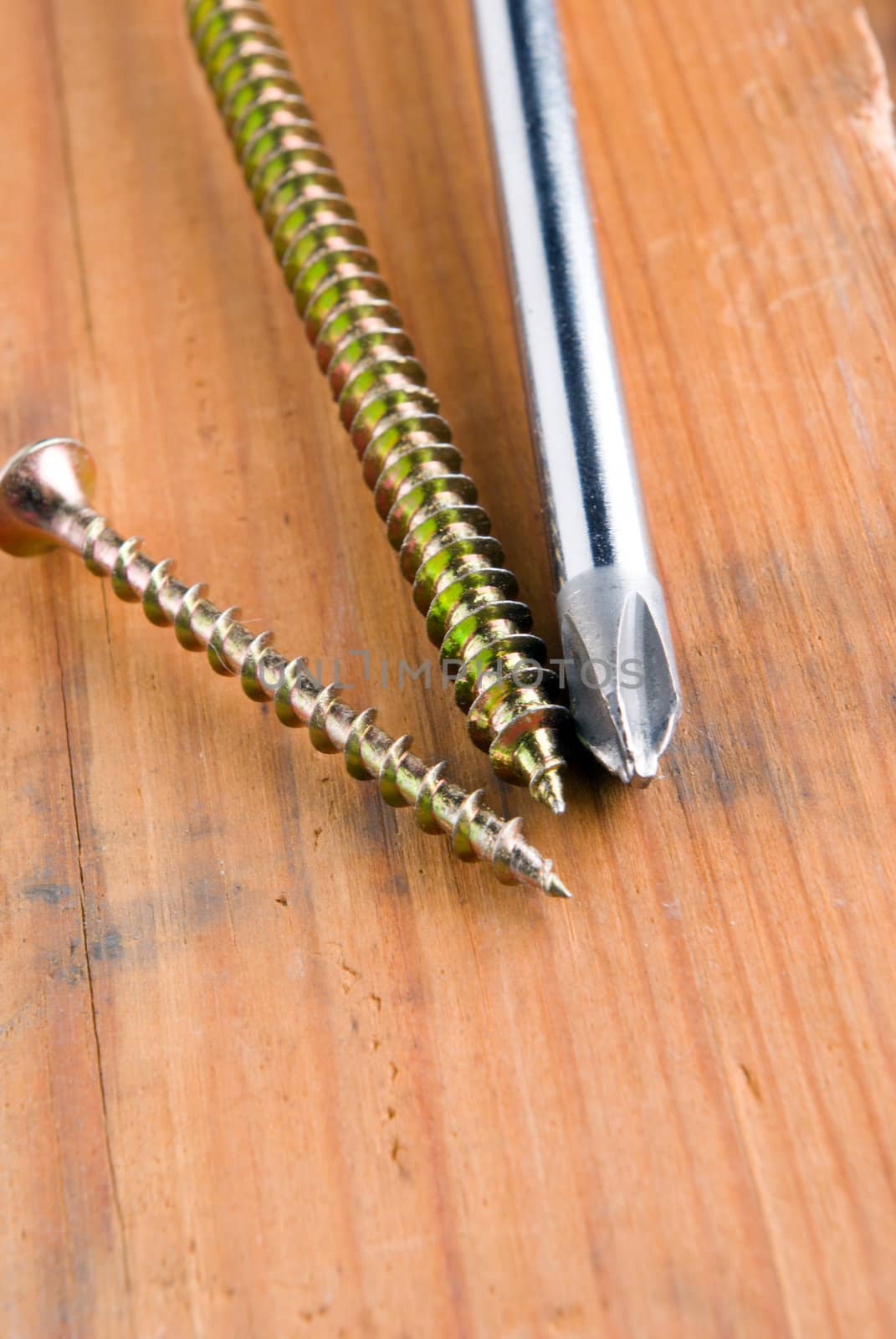 Screw on a wooden background
