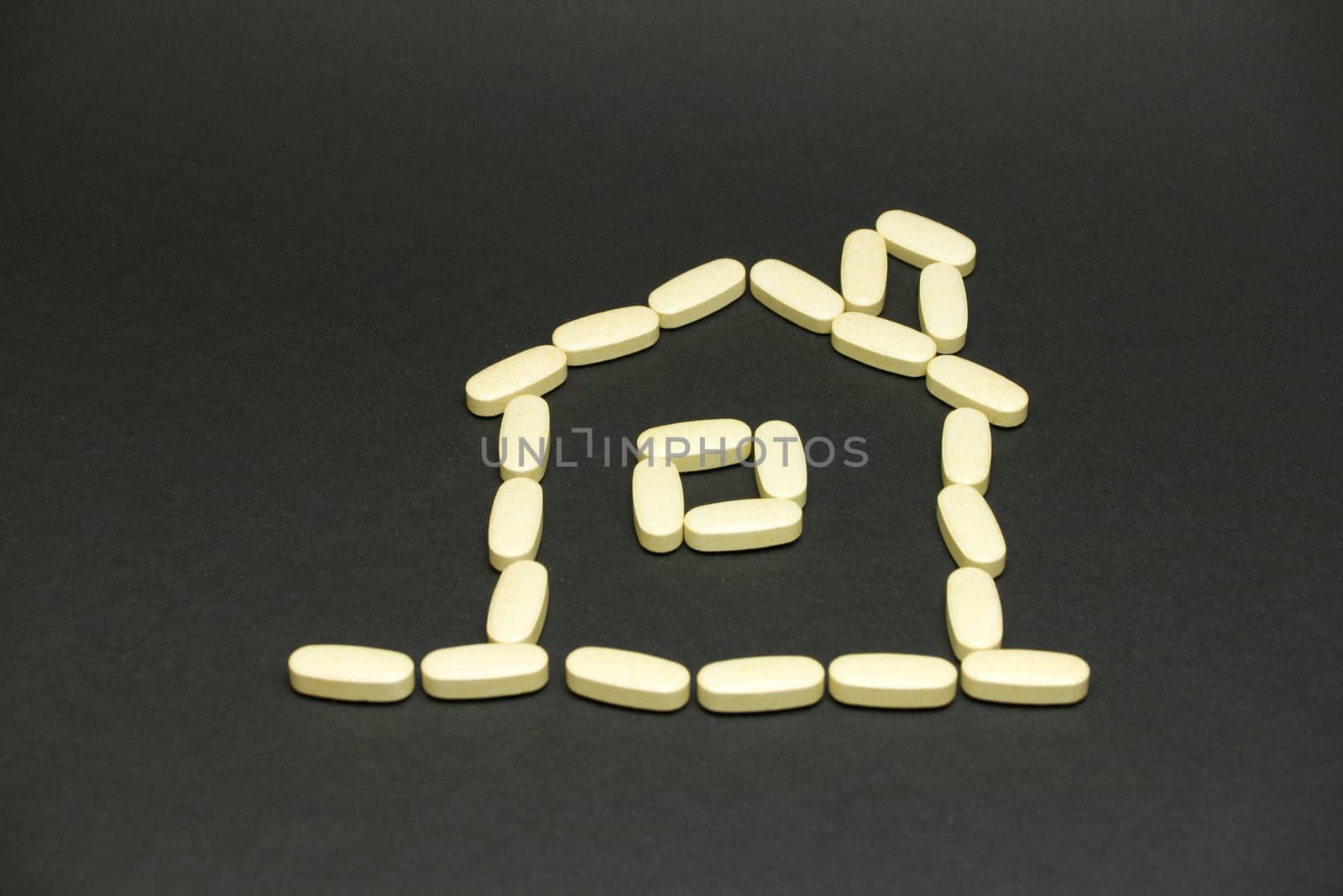 House made of pills on black