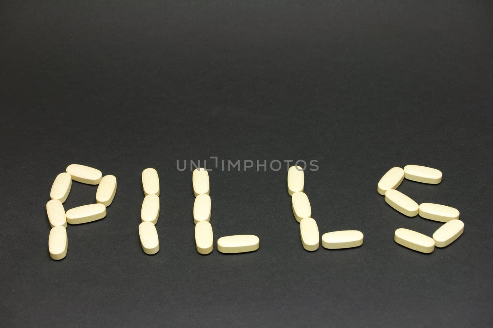 word made of pills on black