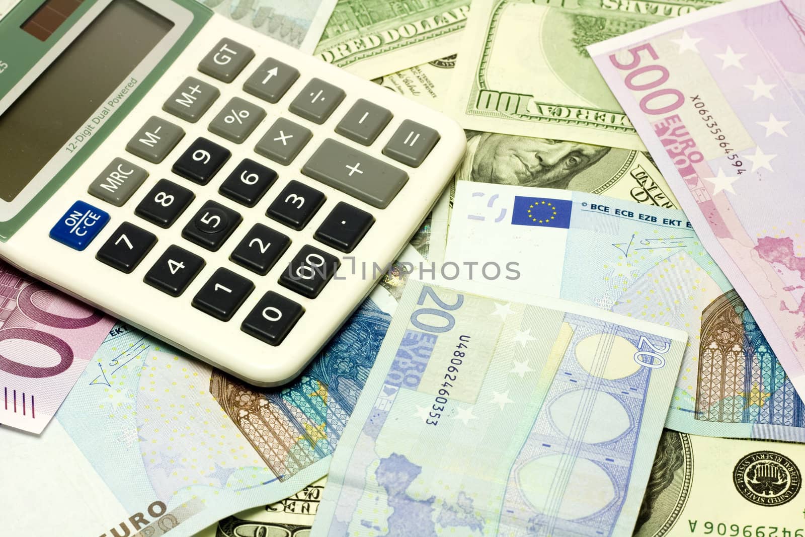 Dollar, euro banknotes, calculator by ursolv