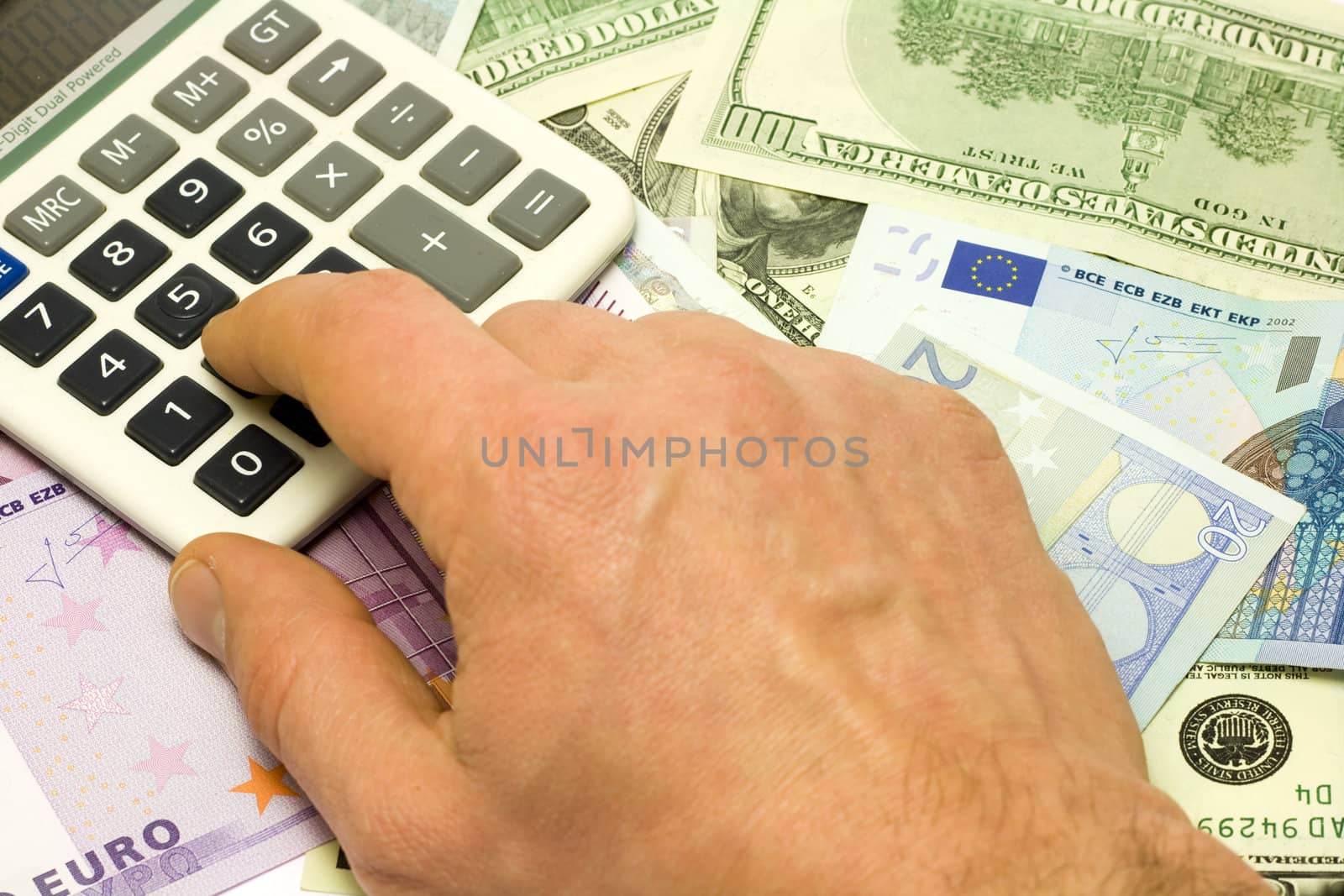 Dollar, euro banknotes, calculator, human hand pushing button