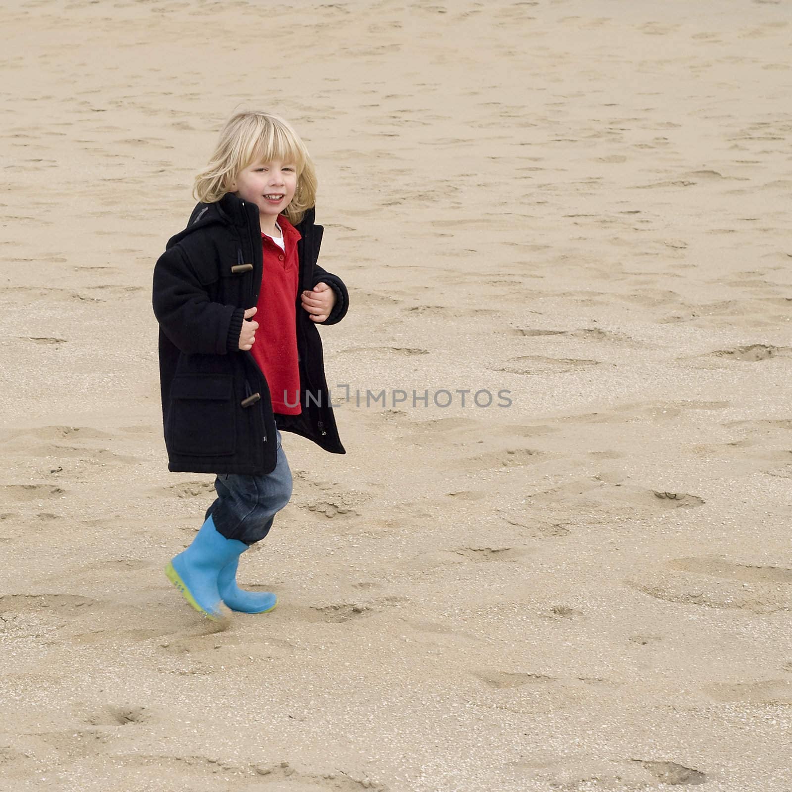 a boy walking on the beach