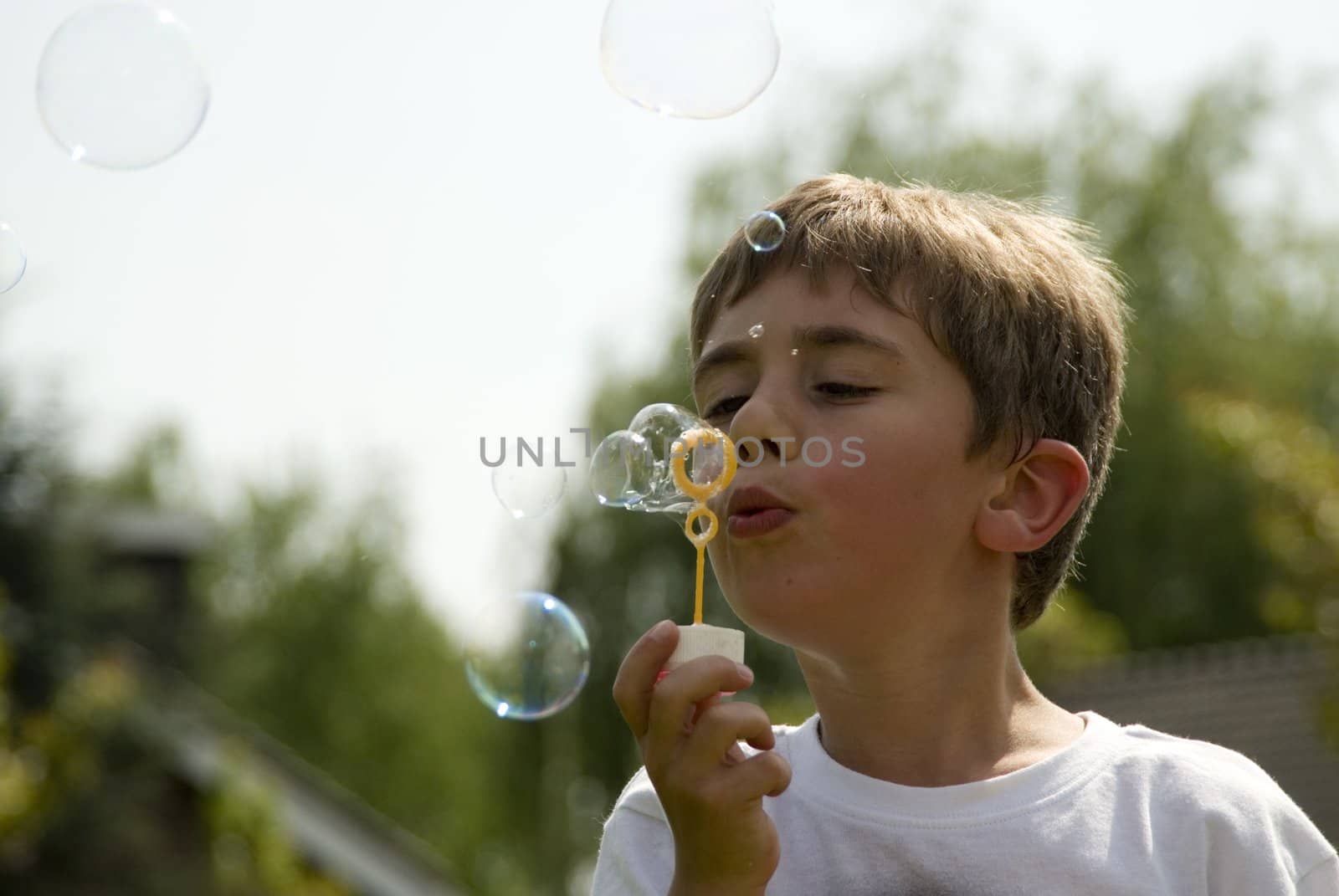 Boy blowing soap bubbles