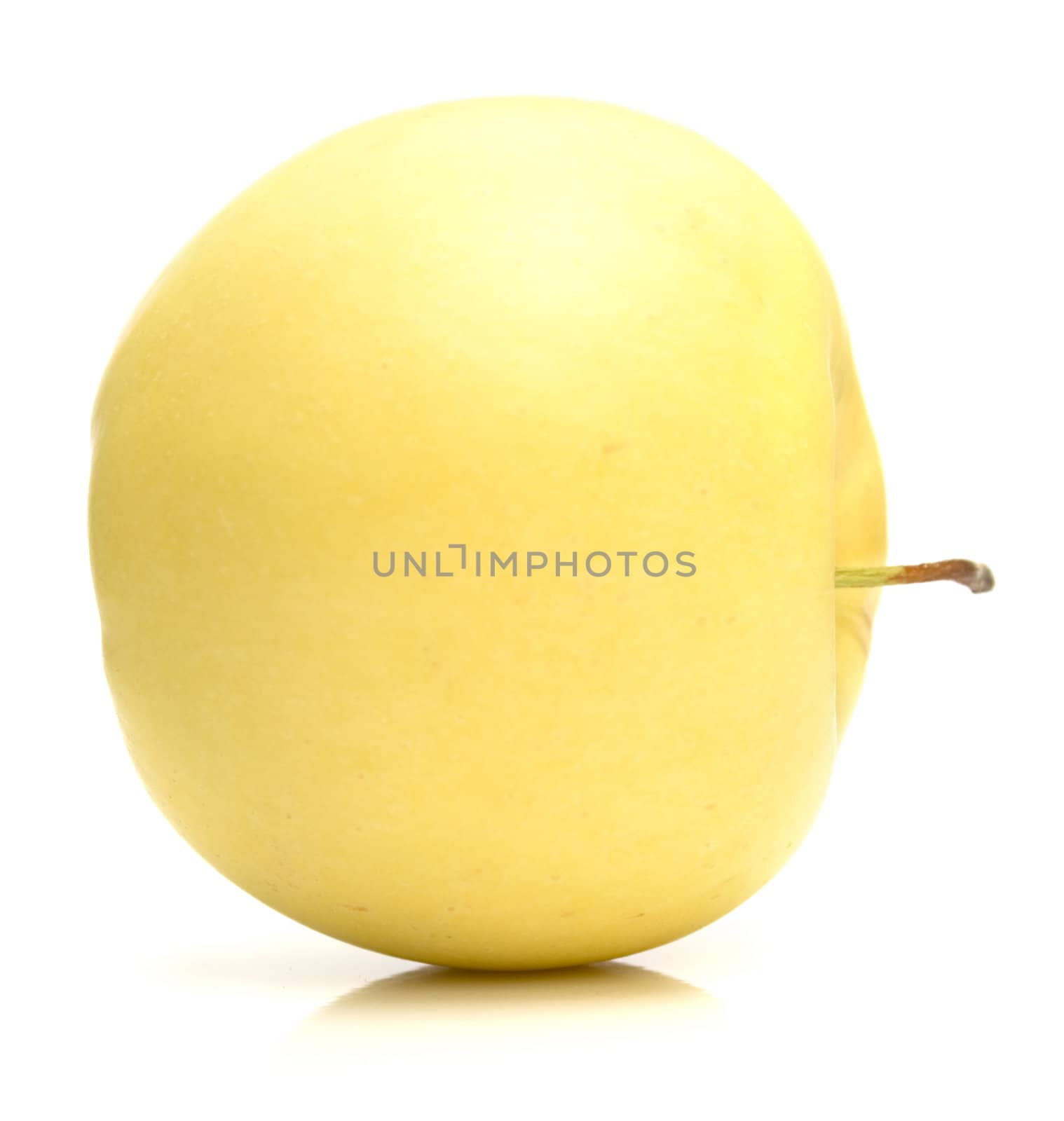 The ripe juicy yellow apple . Isolation on white, shallow DOF.