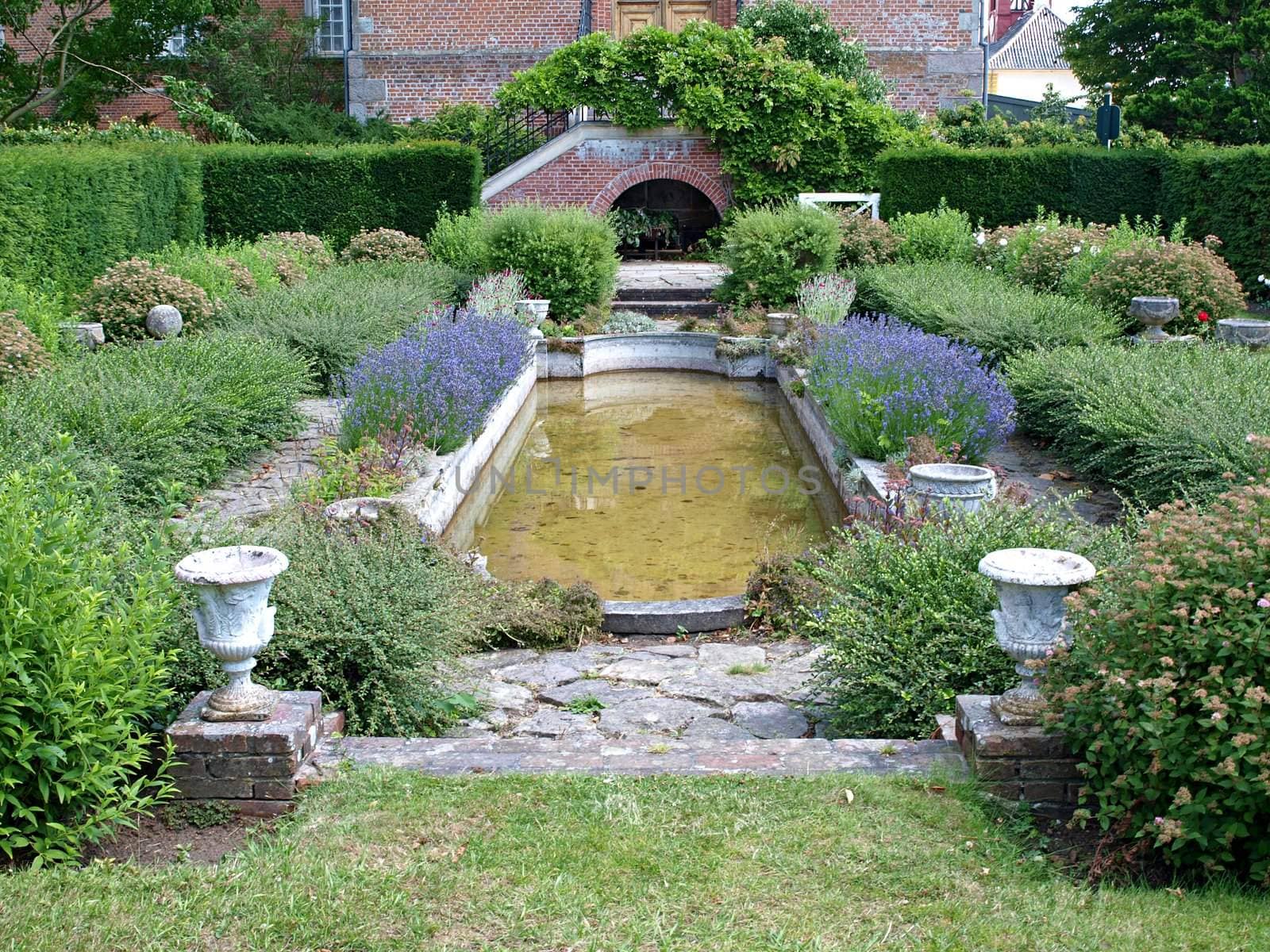 Decorative classical style garden with a water pond      
