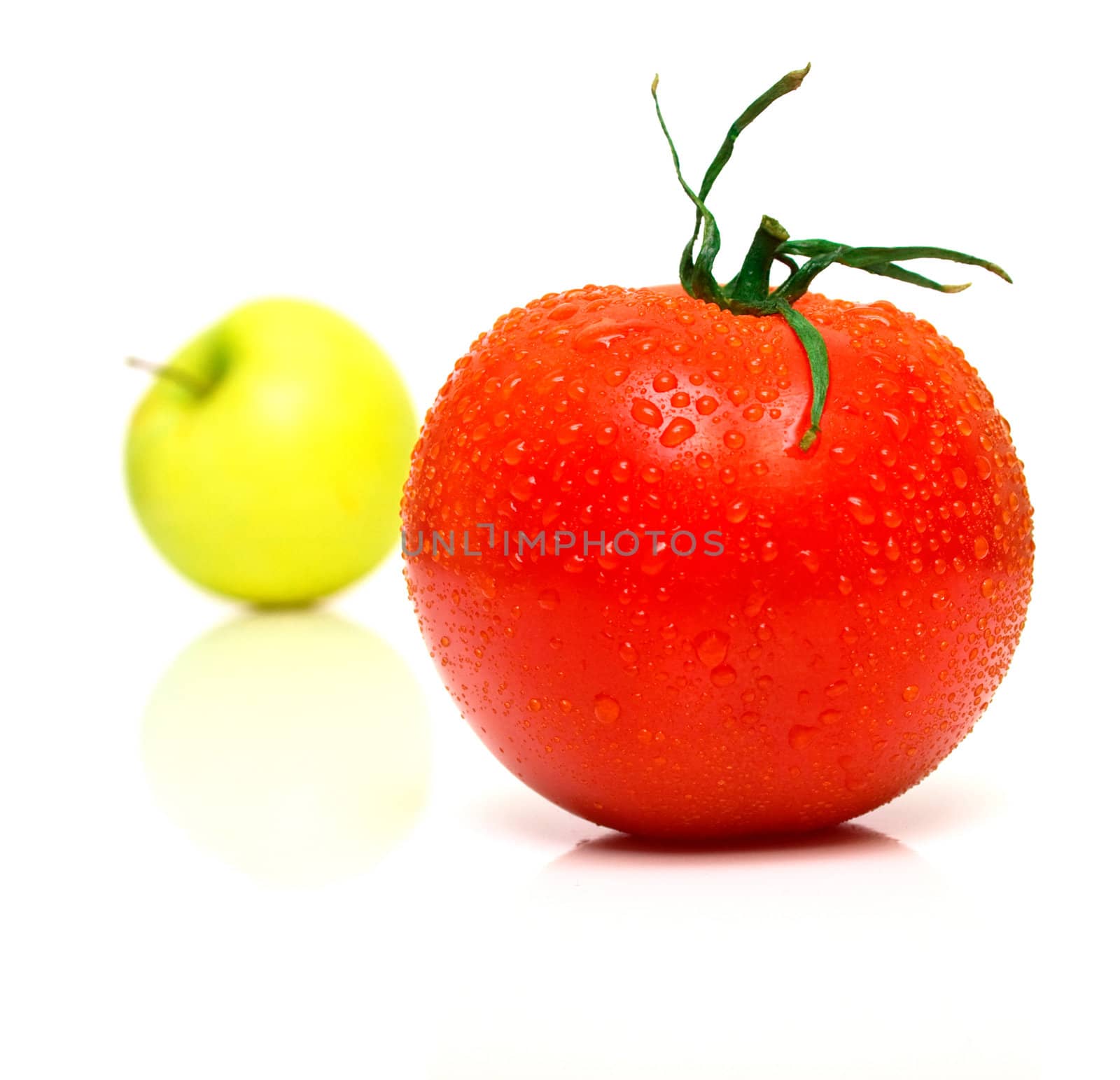 Yellow apple and tomato. Shallow DOF. Focus on a red tomato.