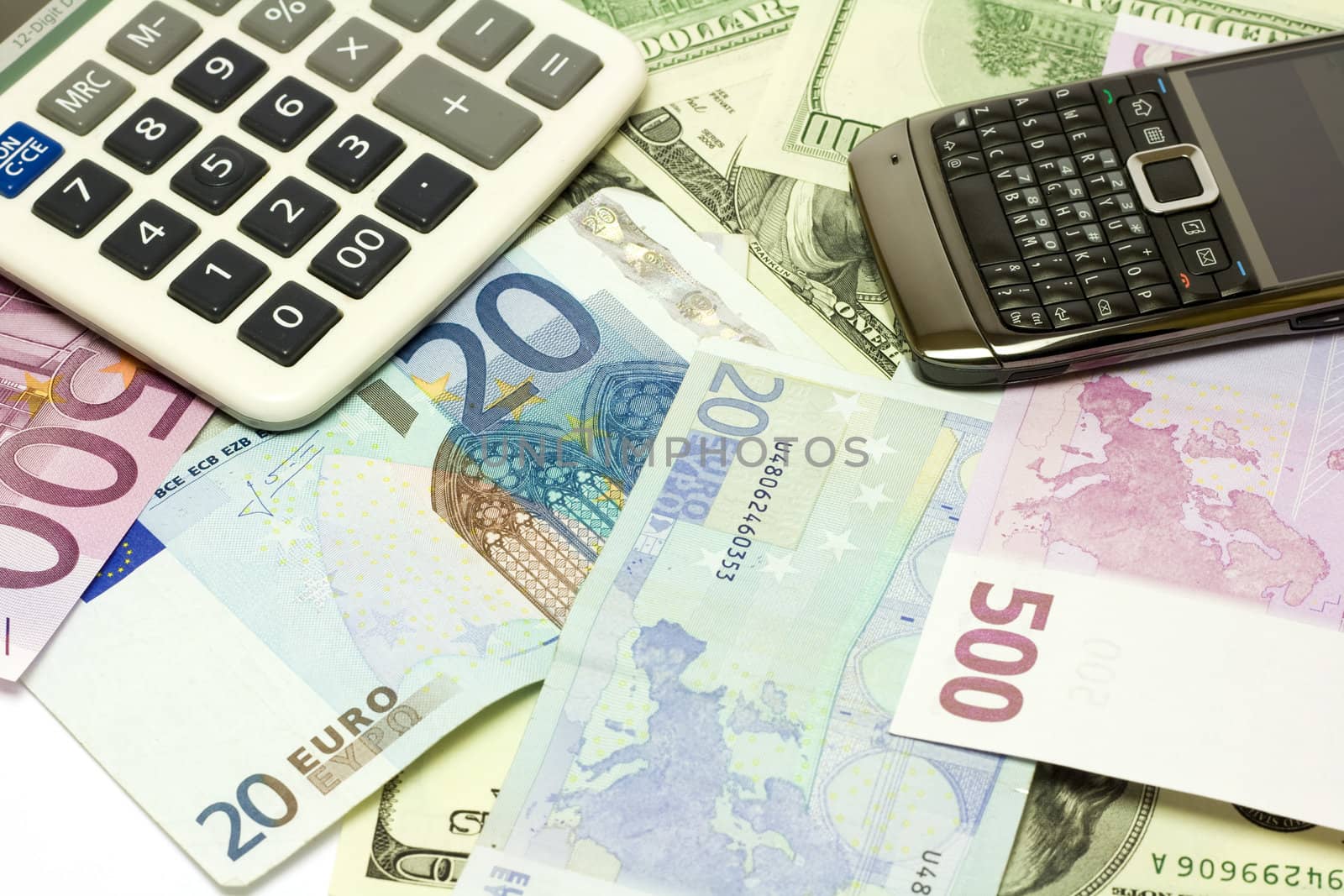 Dollar, euro banknotes, calculator and cellphone by ursolv