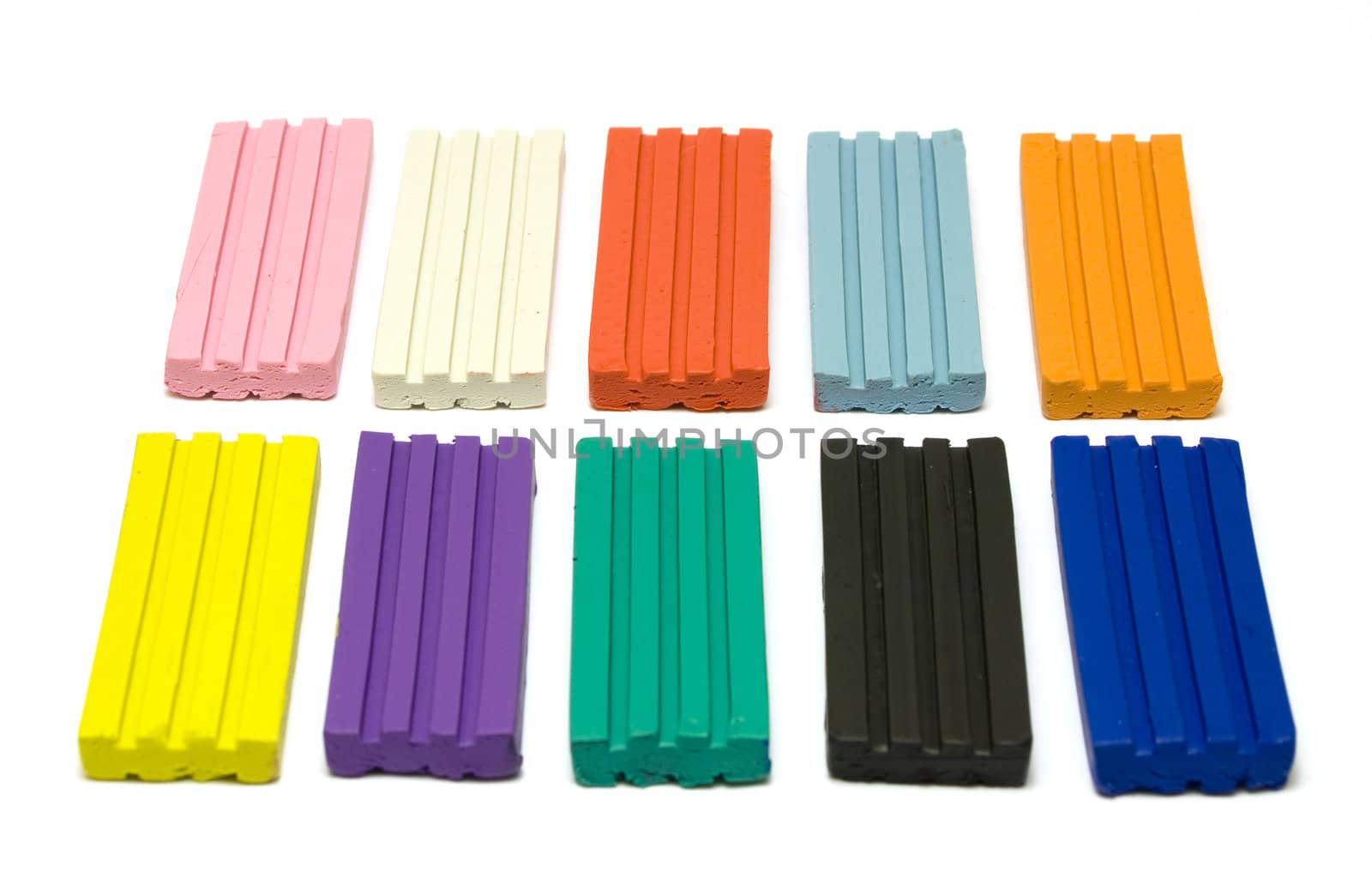 Colorful plasticine bricks on white