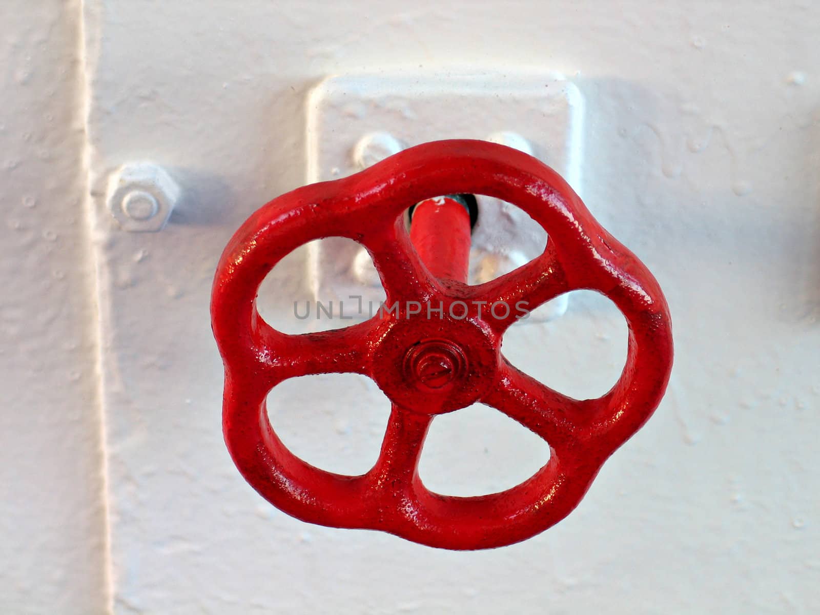 Red emergency industrial tap on a ship in closeup view