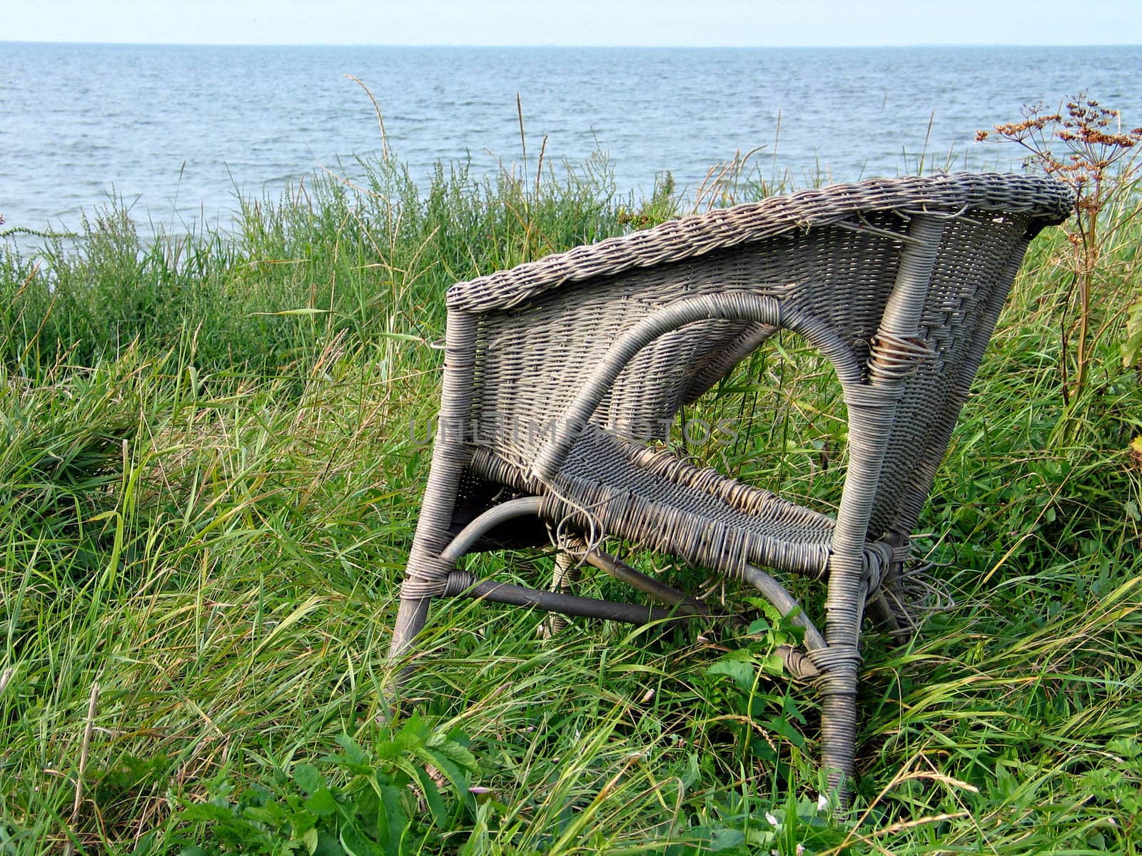 Old abandoned chair on the beach