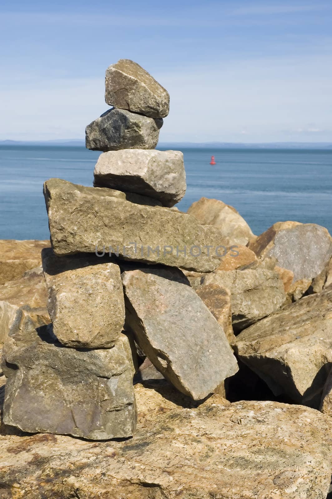 a rock statue built near the ocean