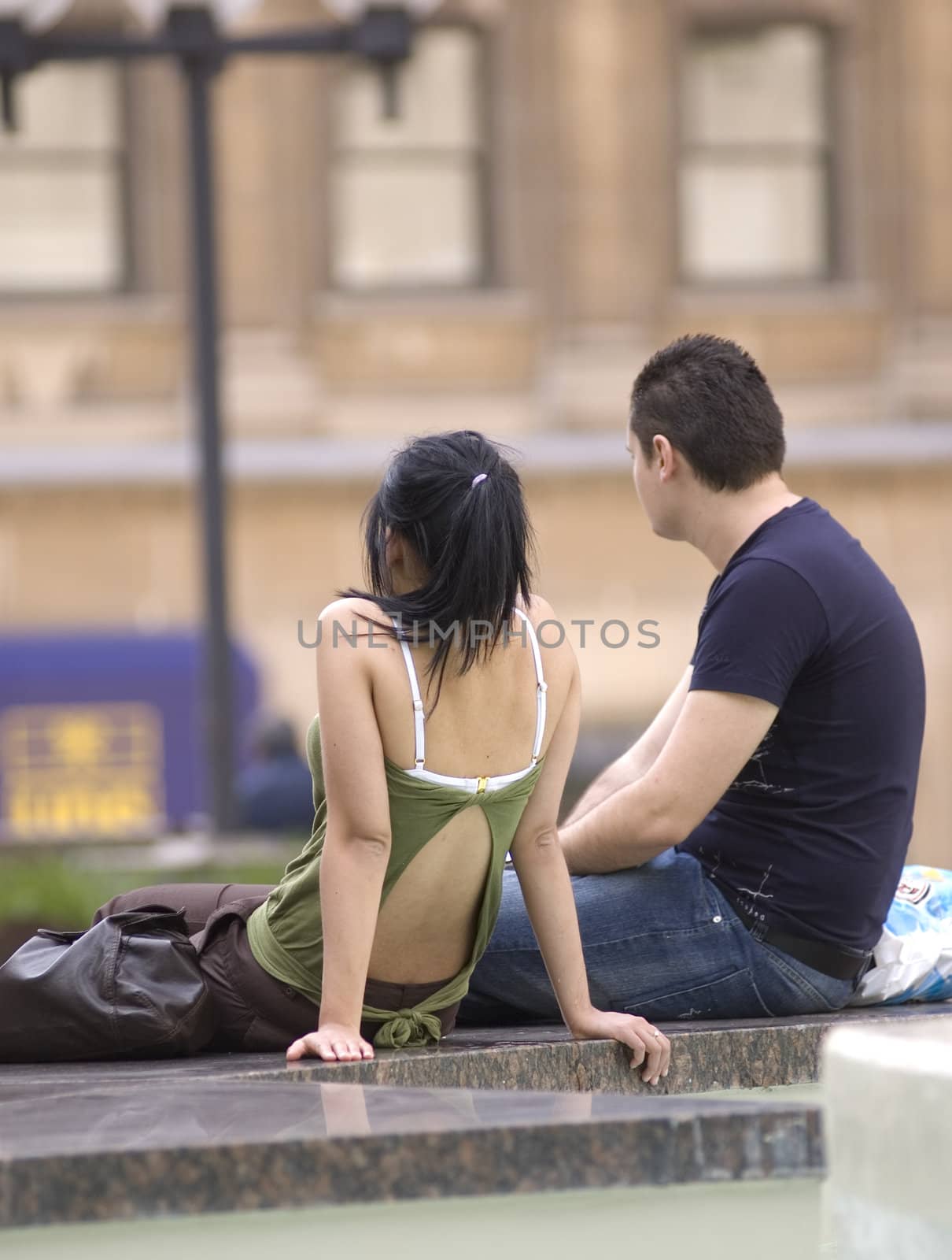 a couple sitting by a fountain and relaxing
