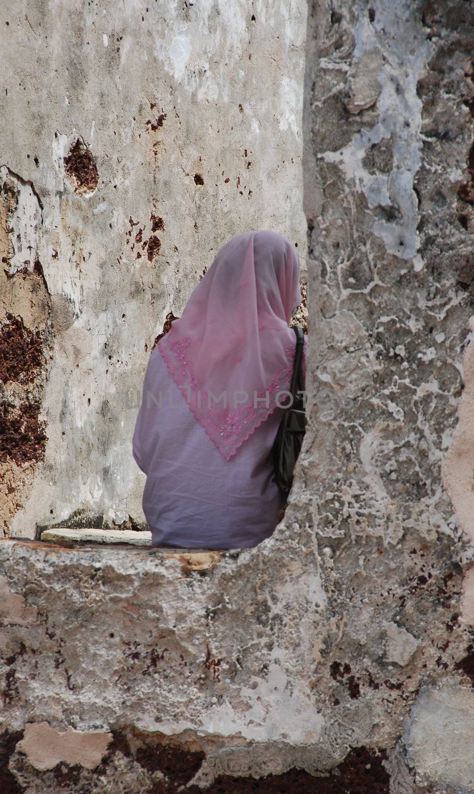 Asian woman posing at a ruin