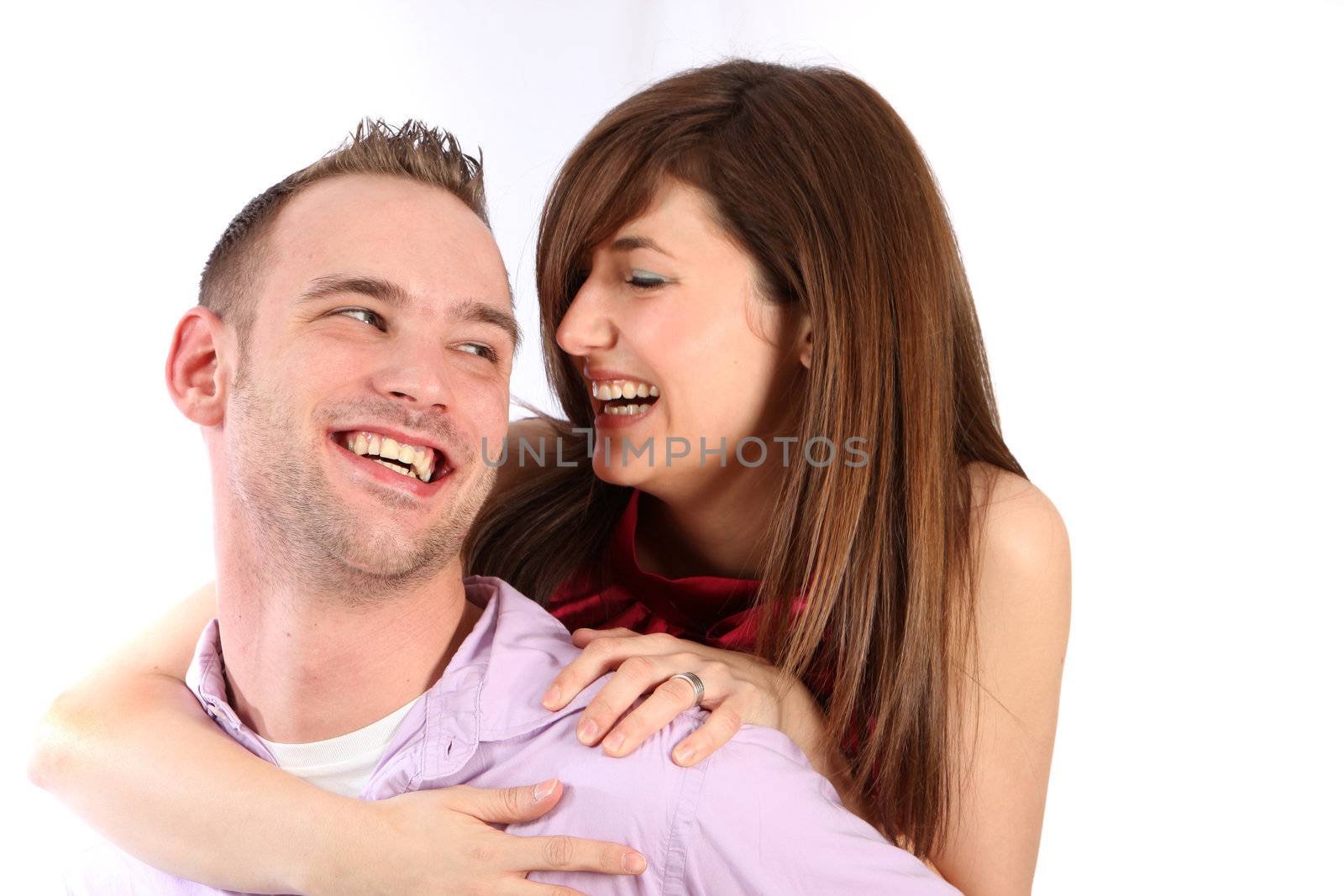 In love, young couple laughing together - space for text