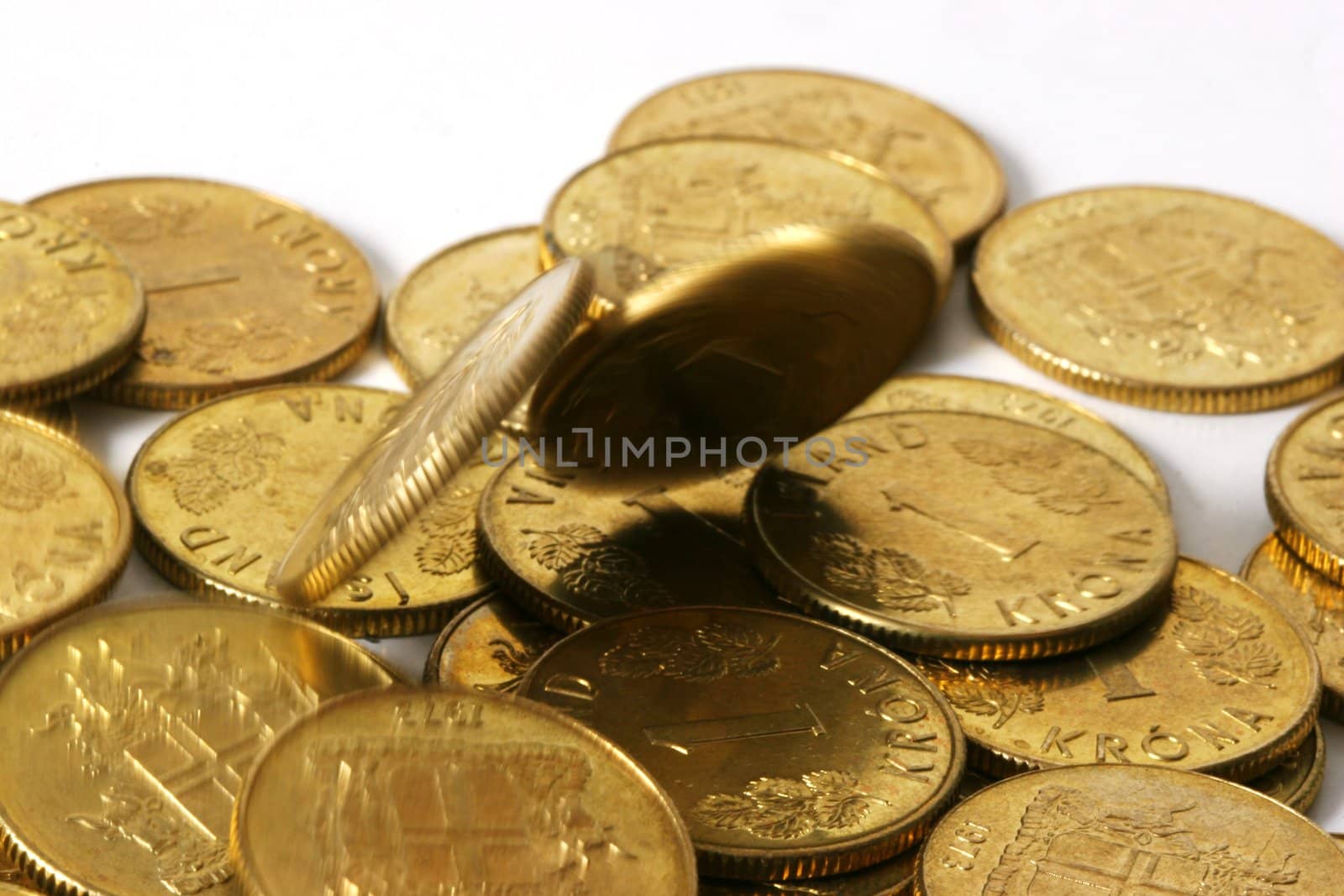 Gold coins motion blurred as they pile up