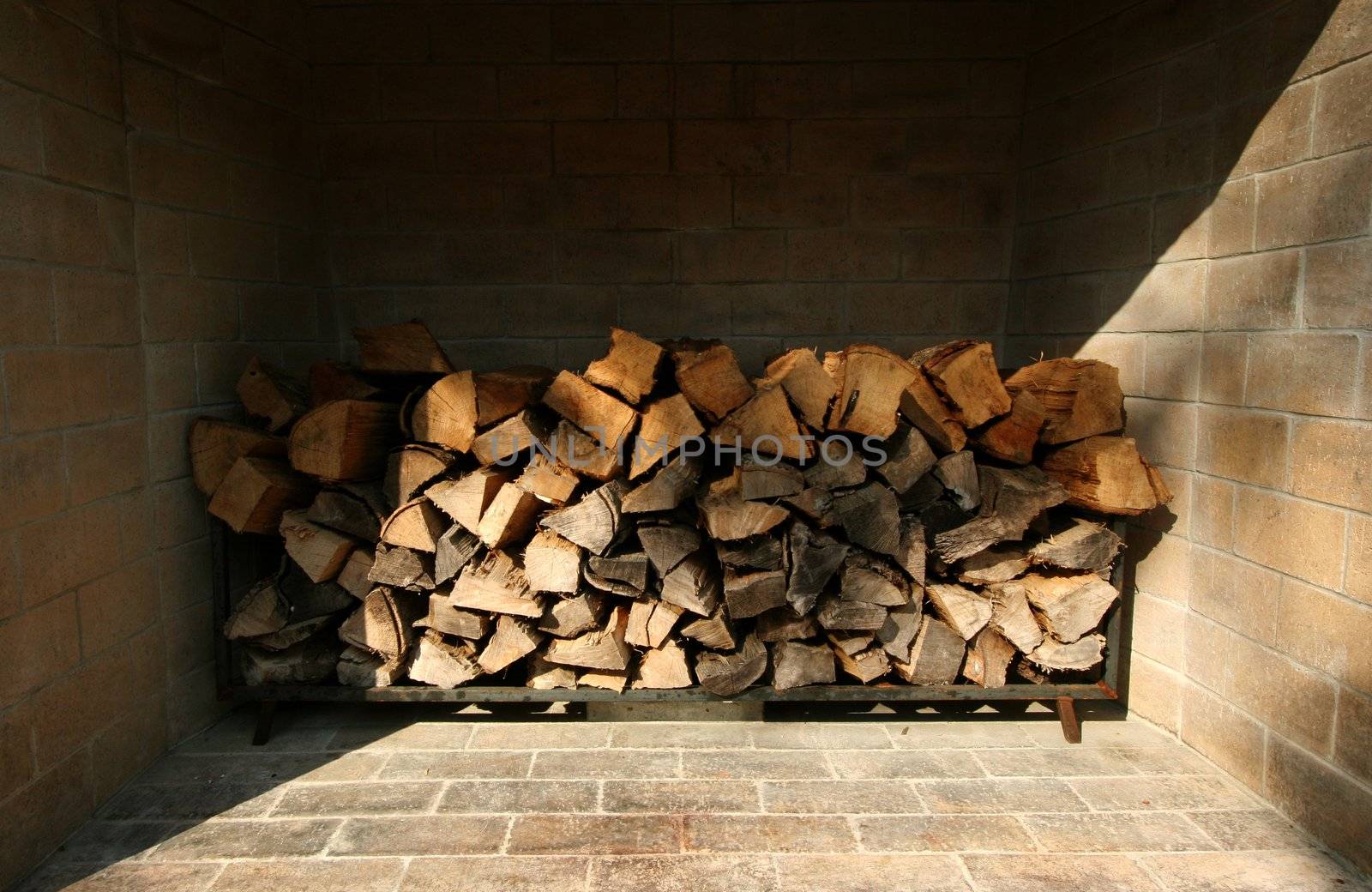 Wood piled up in a fireplace ready to be enjoyed