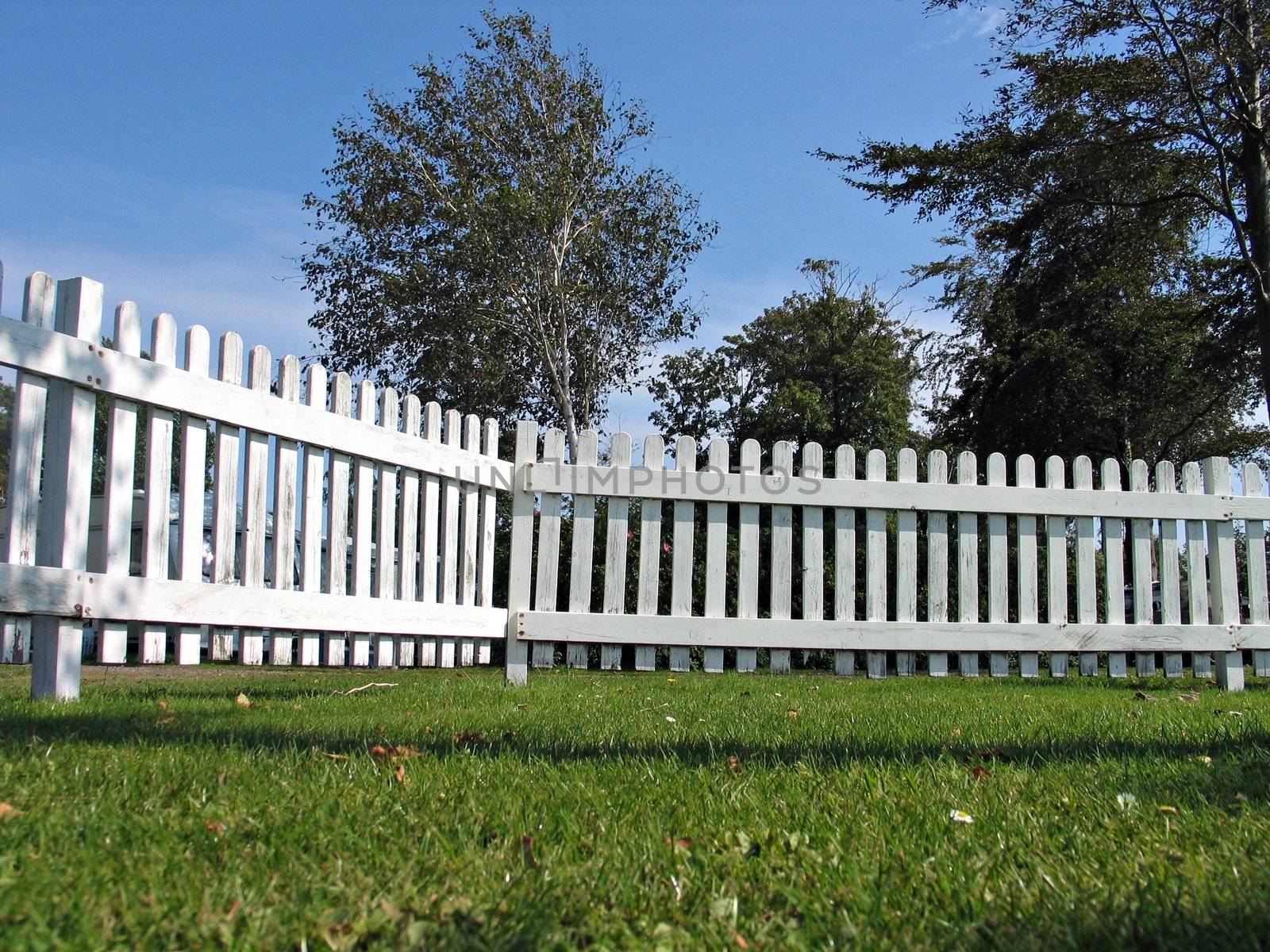 White traditional wood fence taken from ground level