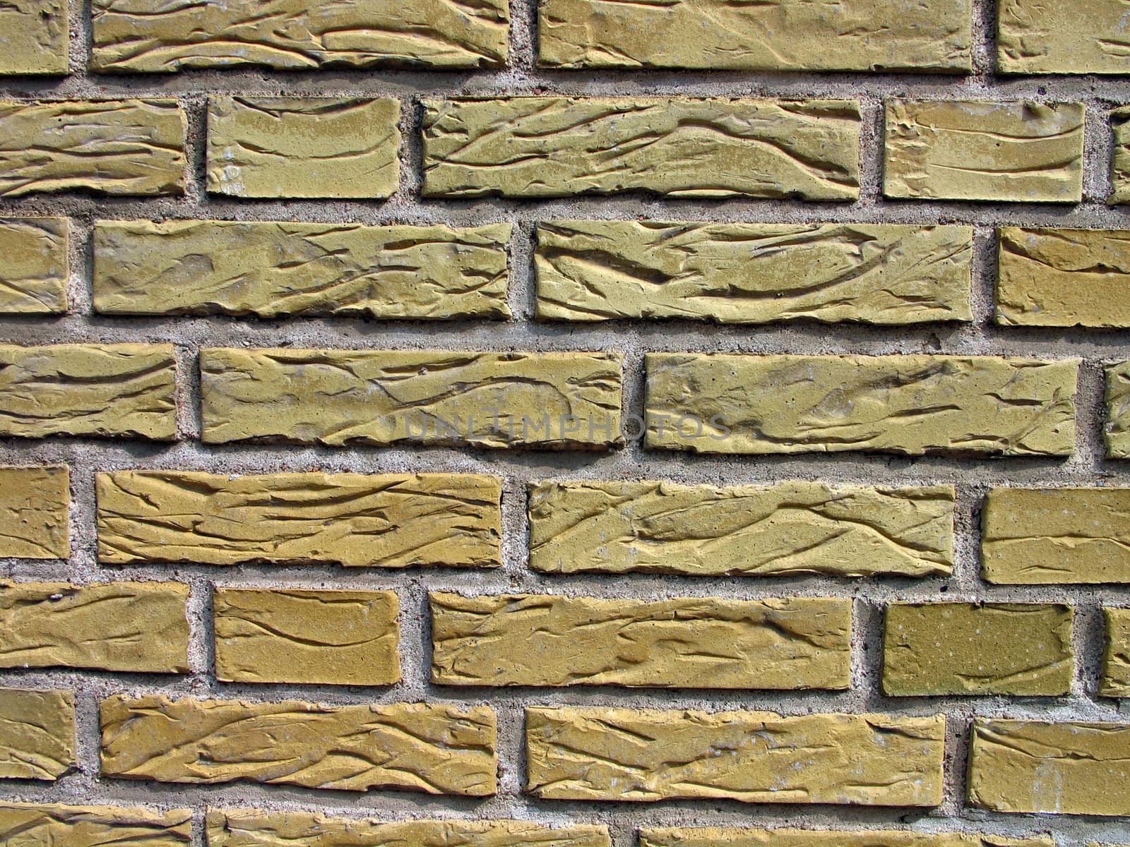 Details of a wall made with carved yellow bricks