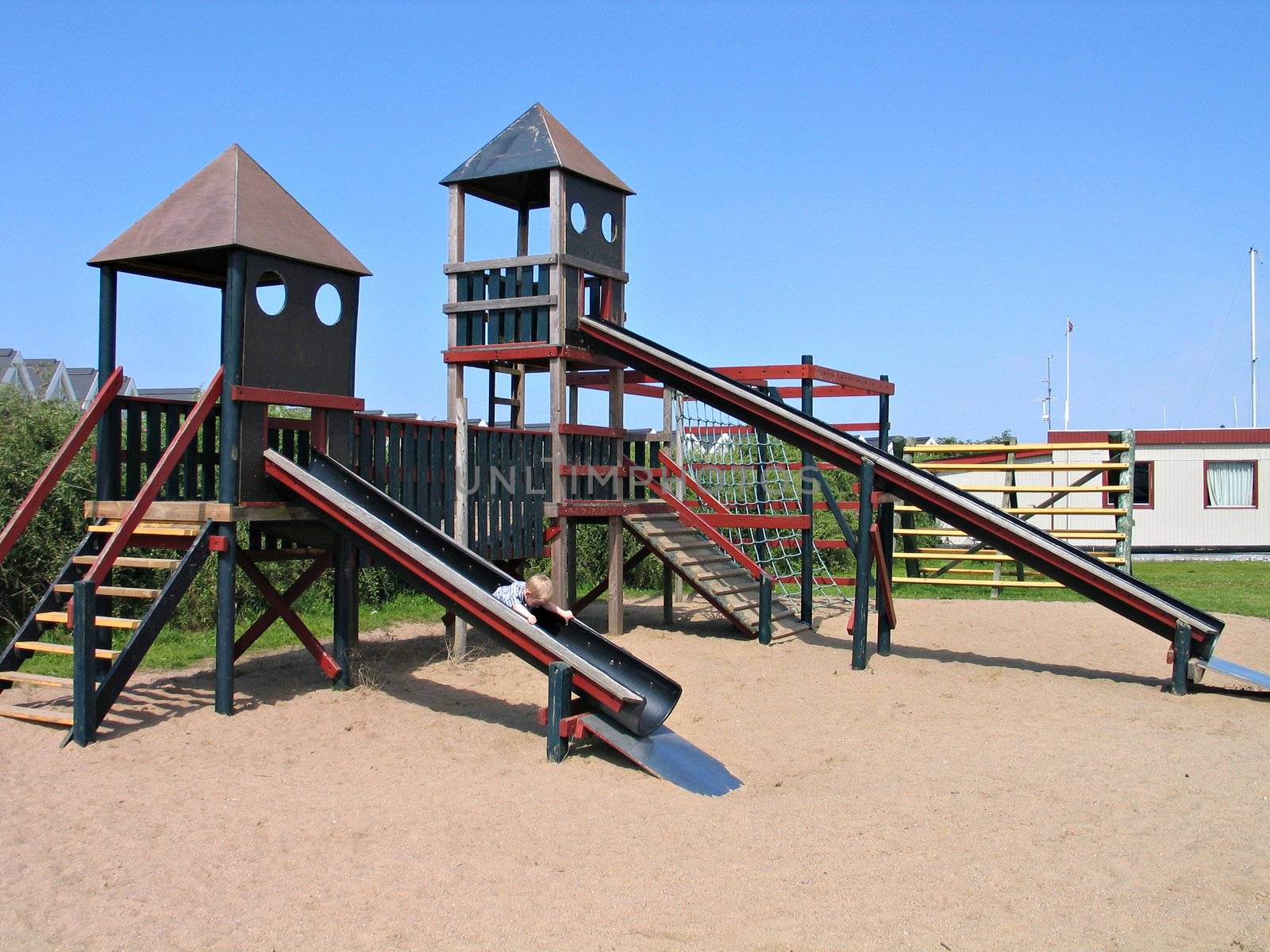 Child slides on a slider in a playground