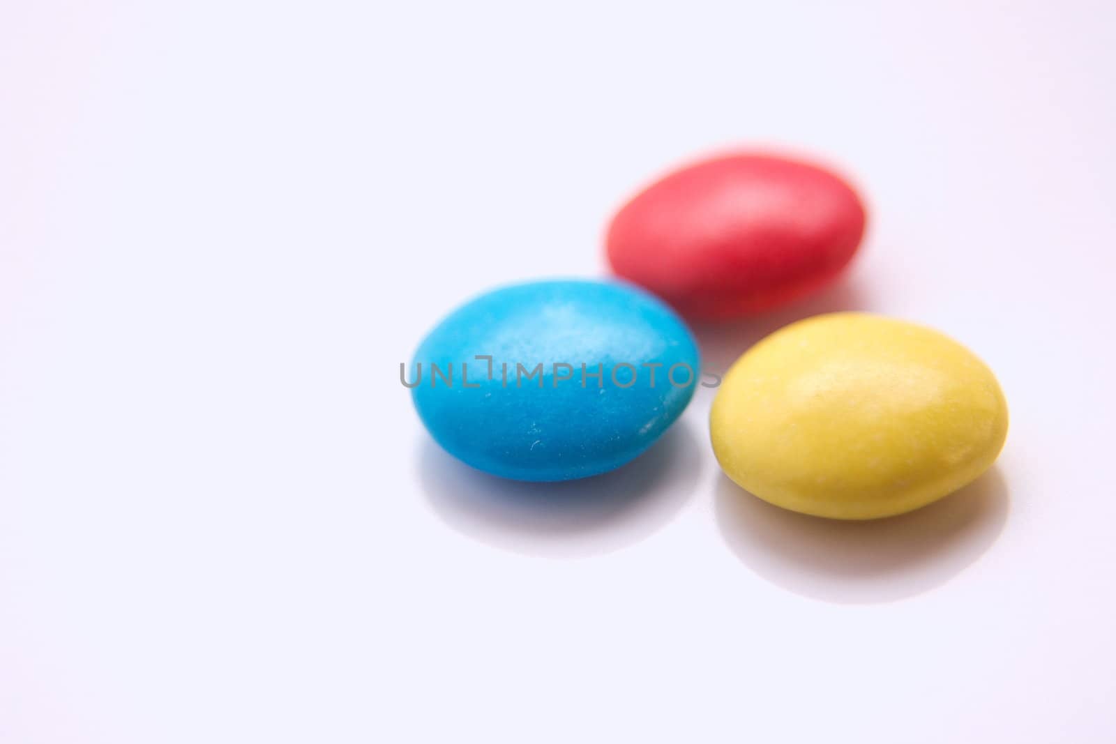 three coloured smarties with the focus on the front two