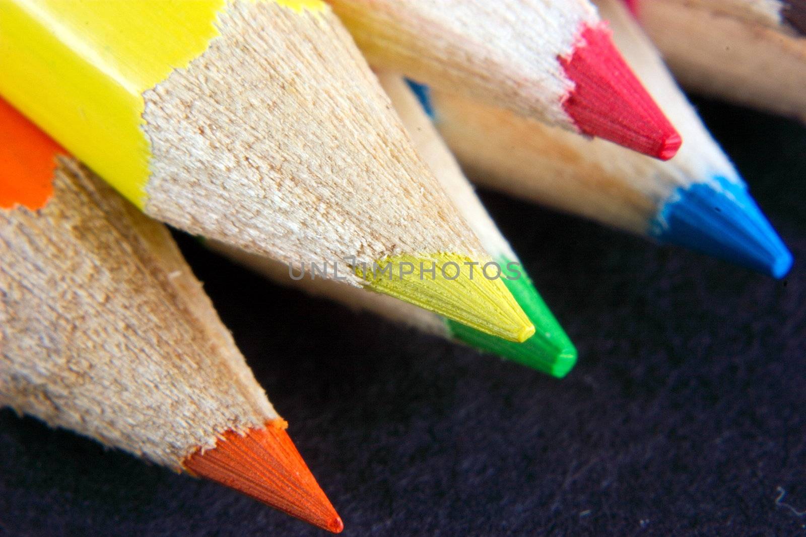 points of crayons over a dark background