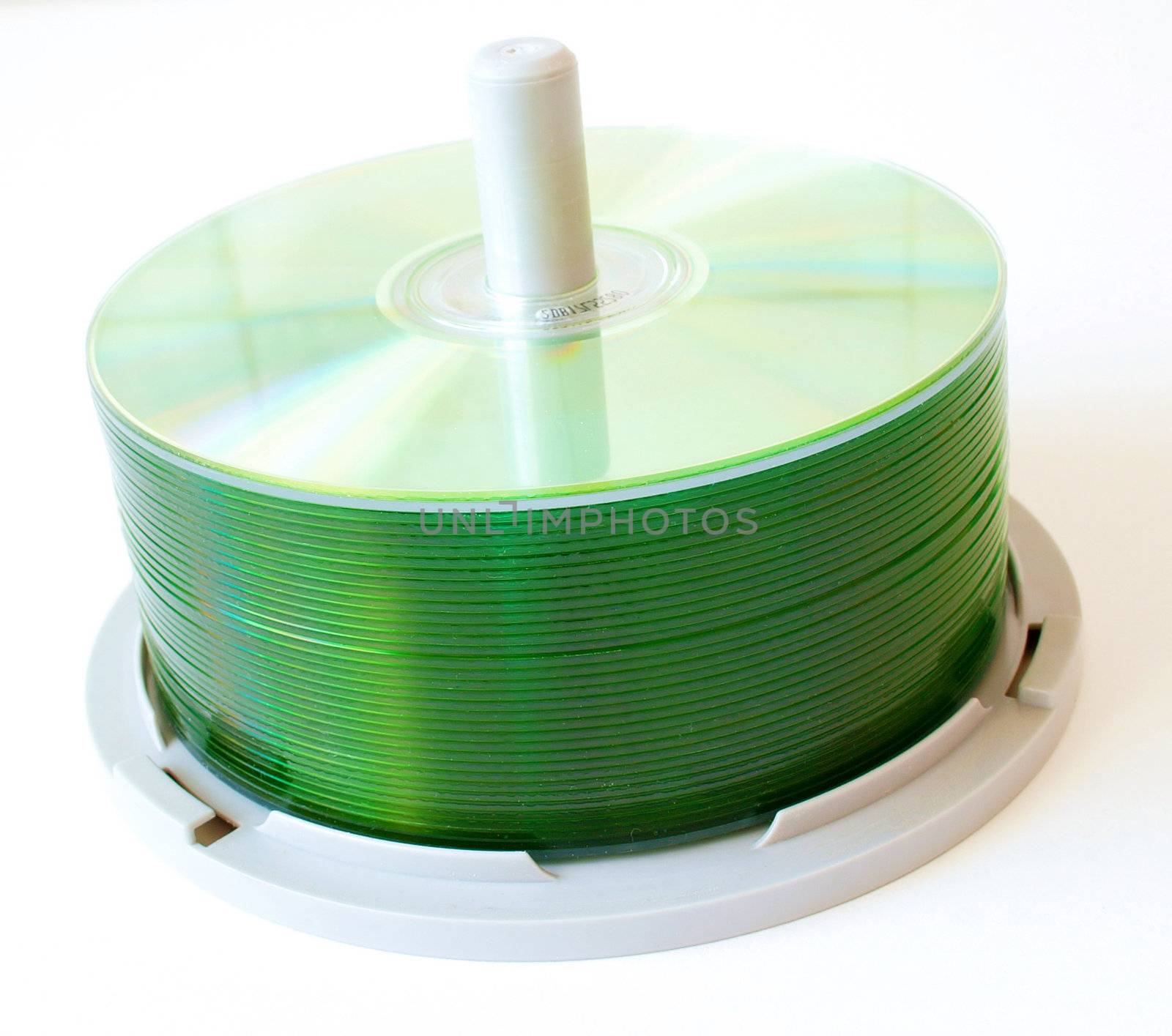 stack of green coloured cds on a stacker stand