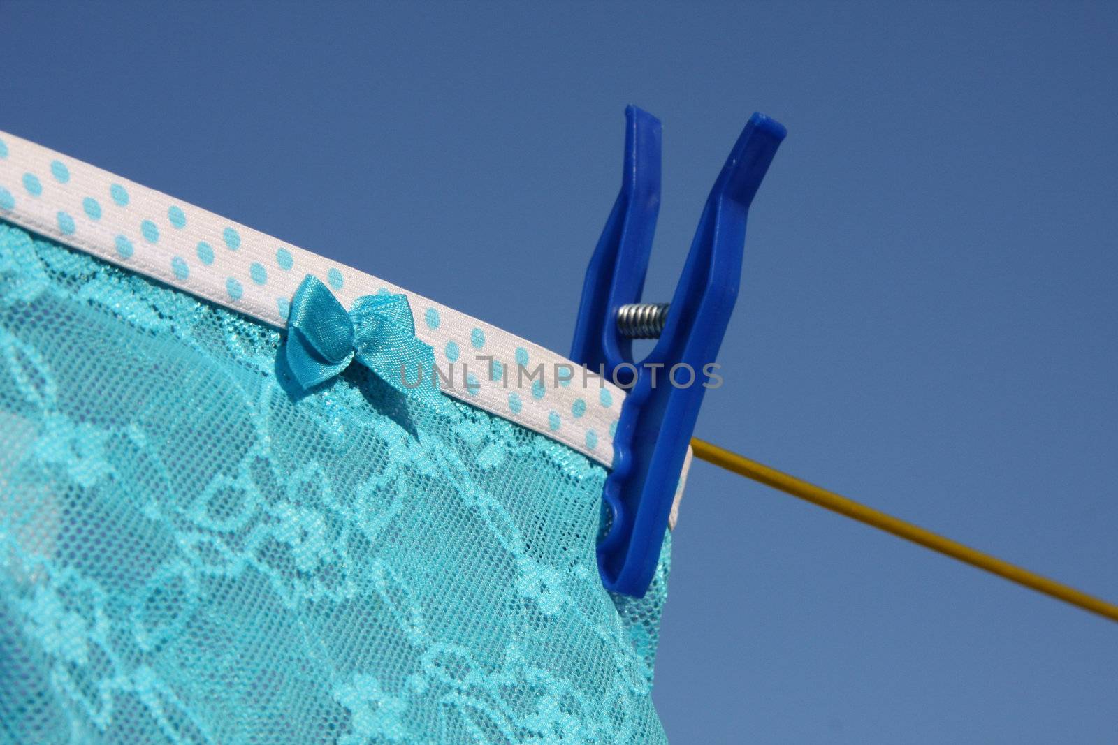 Clothes on washing laundry line, blue lingerie, blue sky