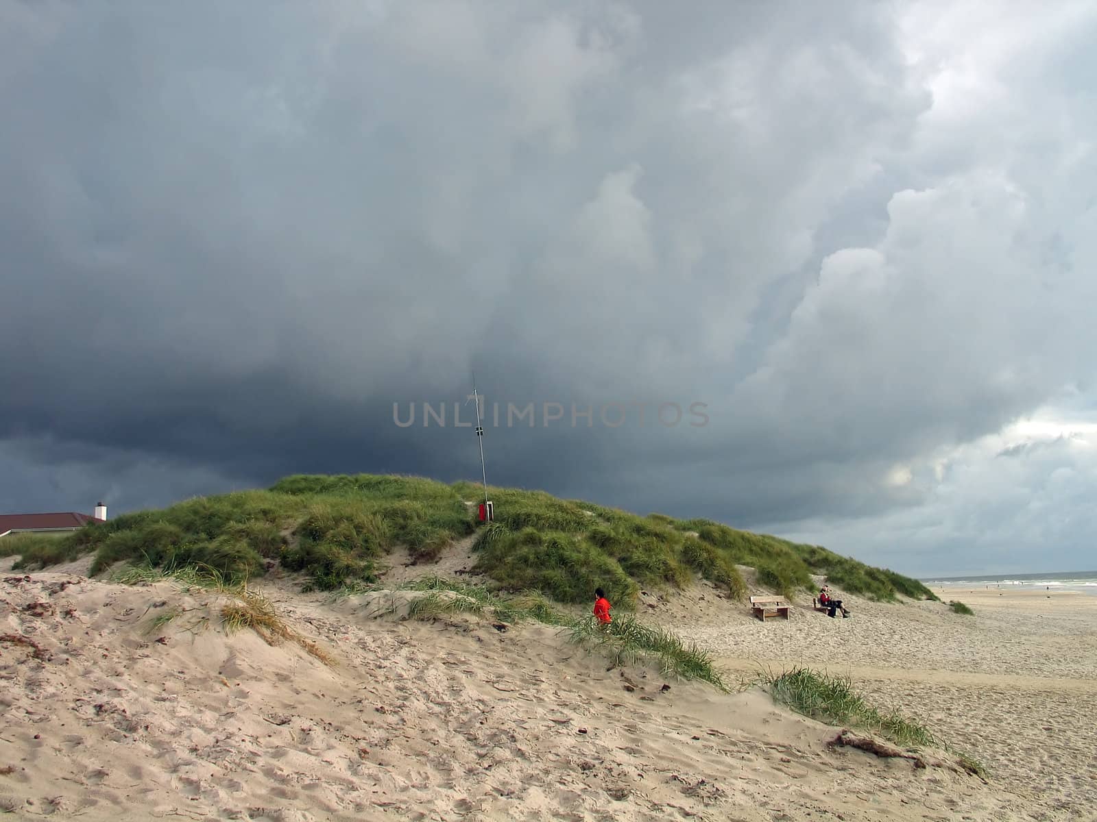 Heavy dark clouds formation on a beach in a stormy winter day