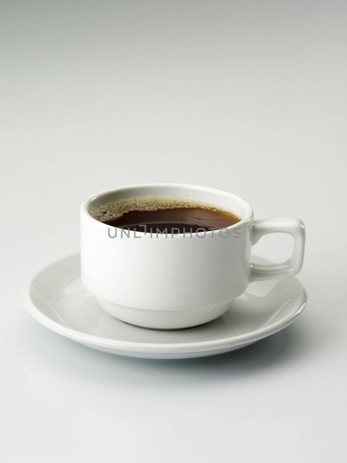 close up of a cup with tea on the plain background