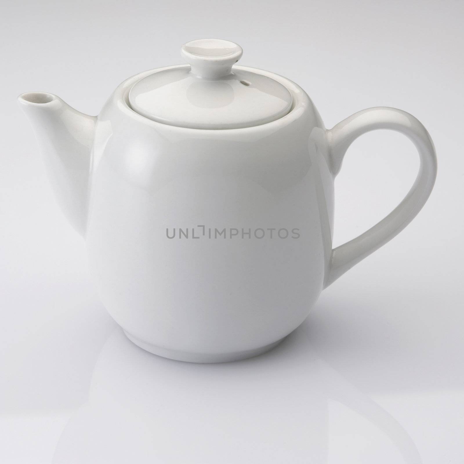 close up of the white tea pot on plain background