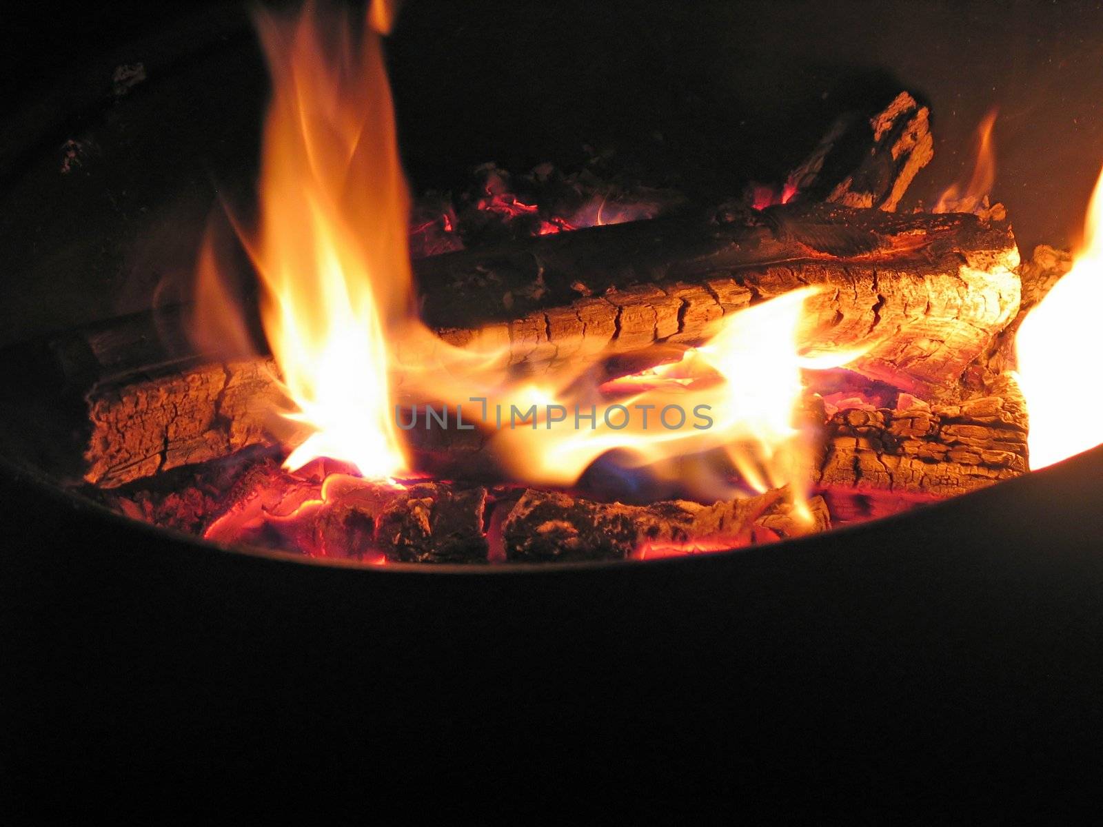 Close up of bonfire pit with blazing flames - black bottom ready for use