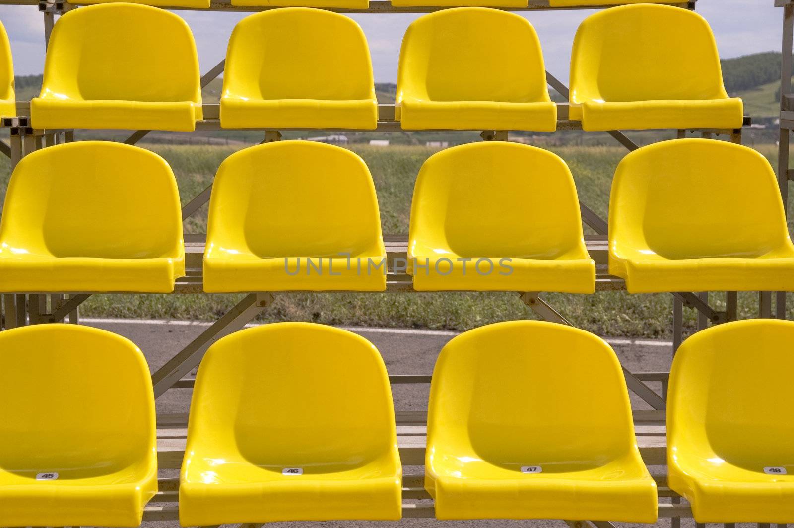 Lines of yellow seats.