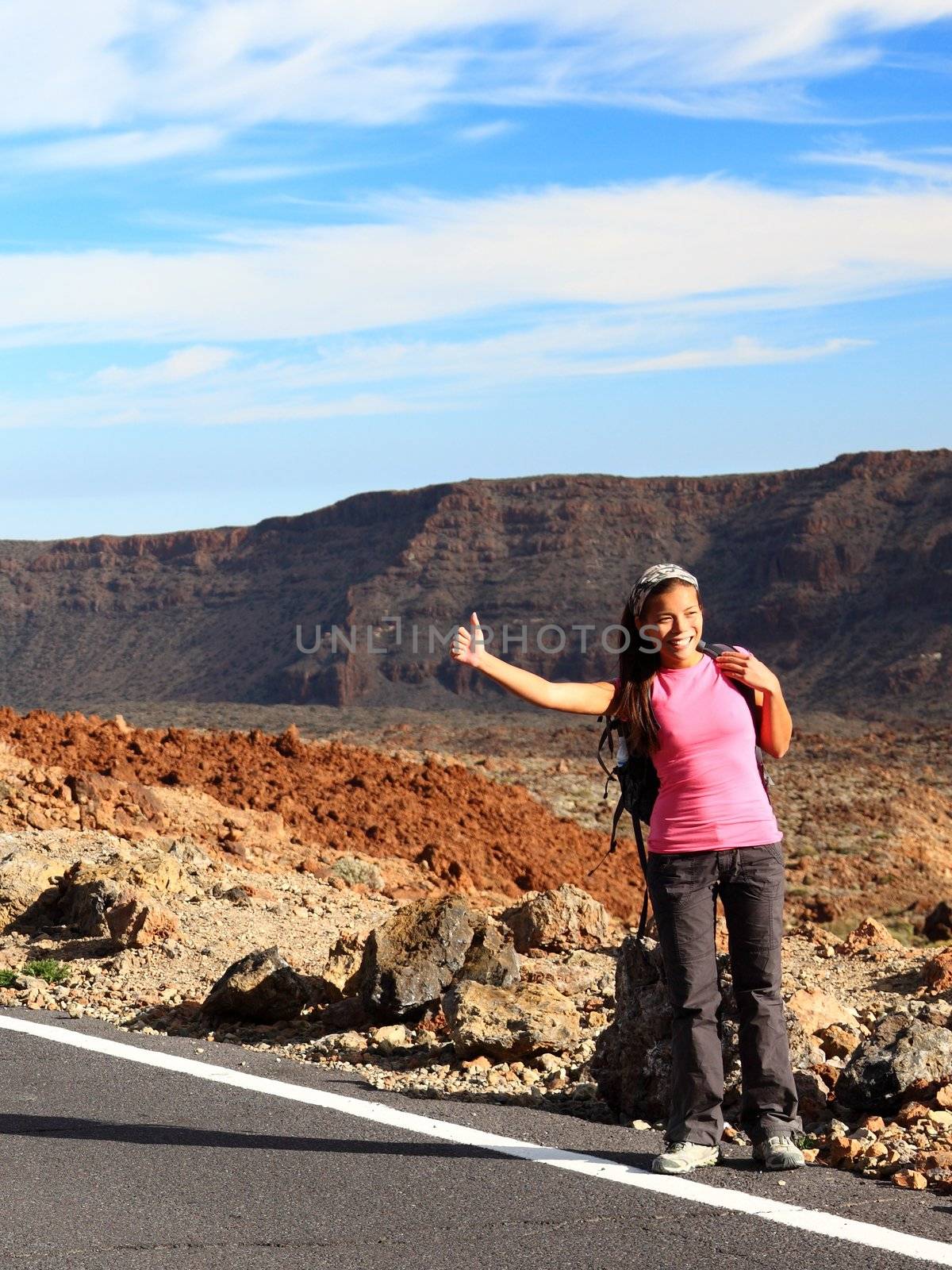Girl Backpacking / Hitchhiking on Teide, Tenerife. Mixed chinese / caucasian woman model.