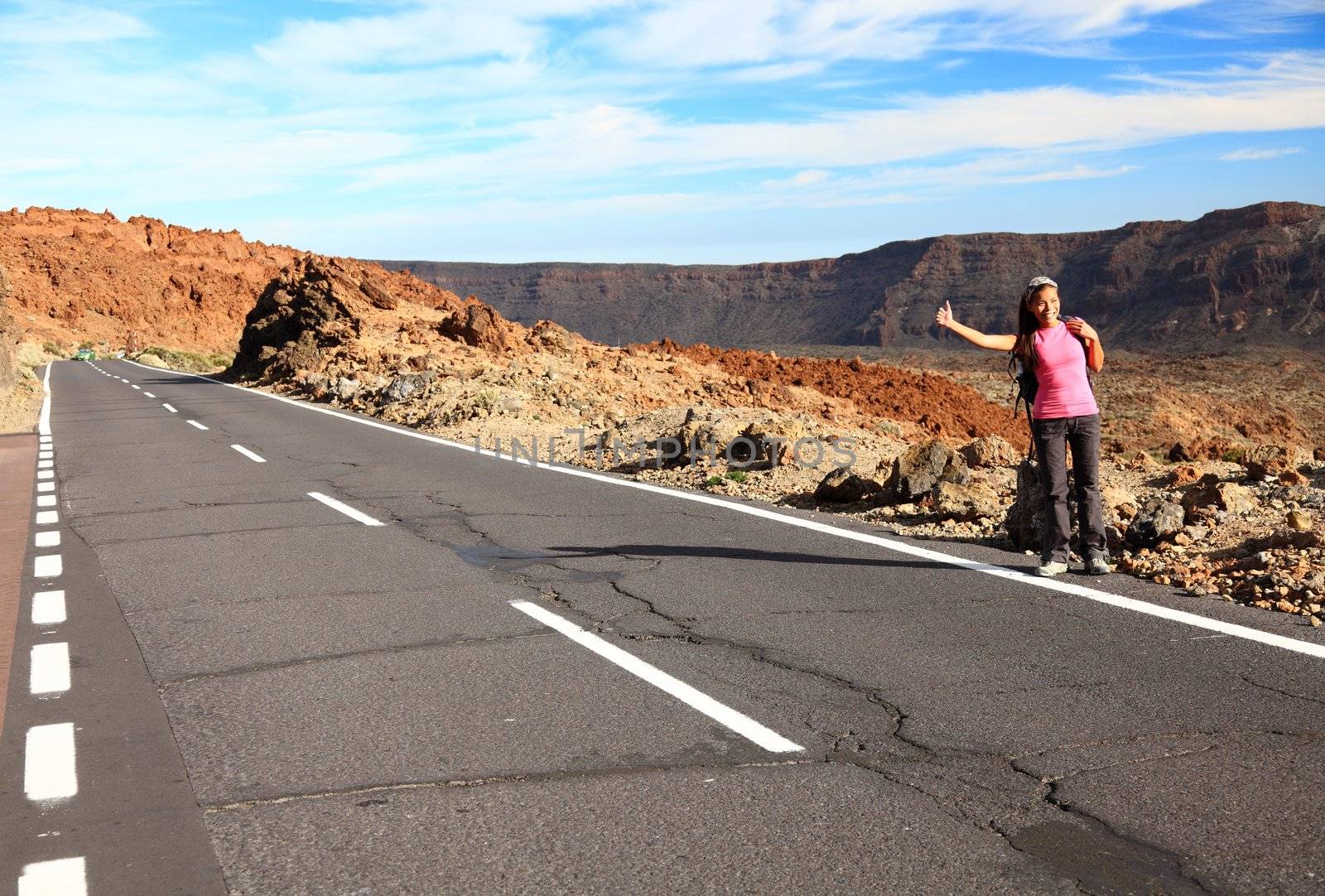 Woman Backpacking / Hitchhiking on Teide, Tenerife. Mixed chinese / caucasian model.