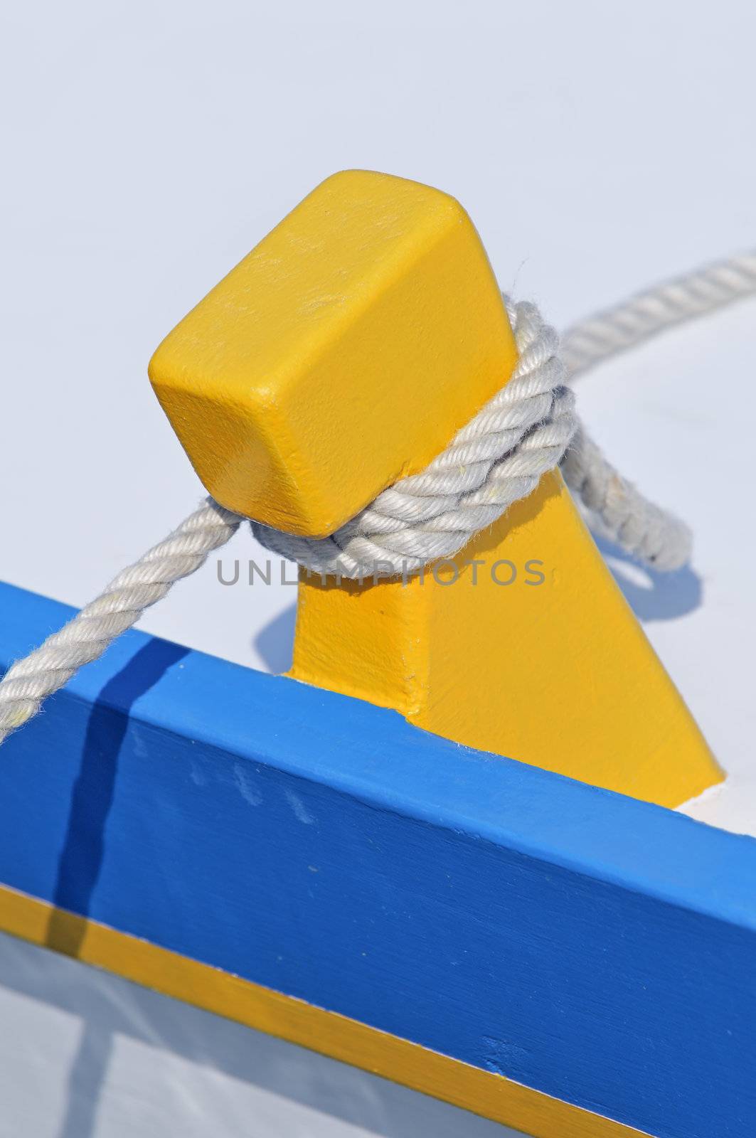Close-up of a yellow and blue boat moored to dock