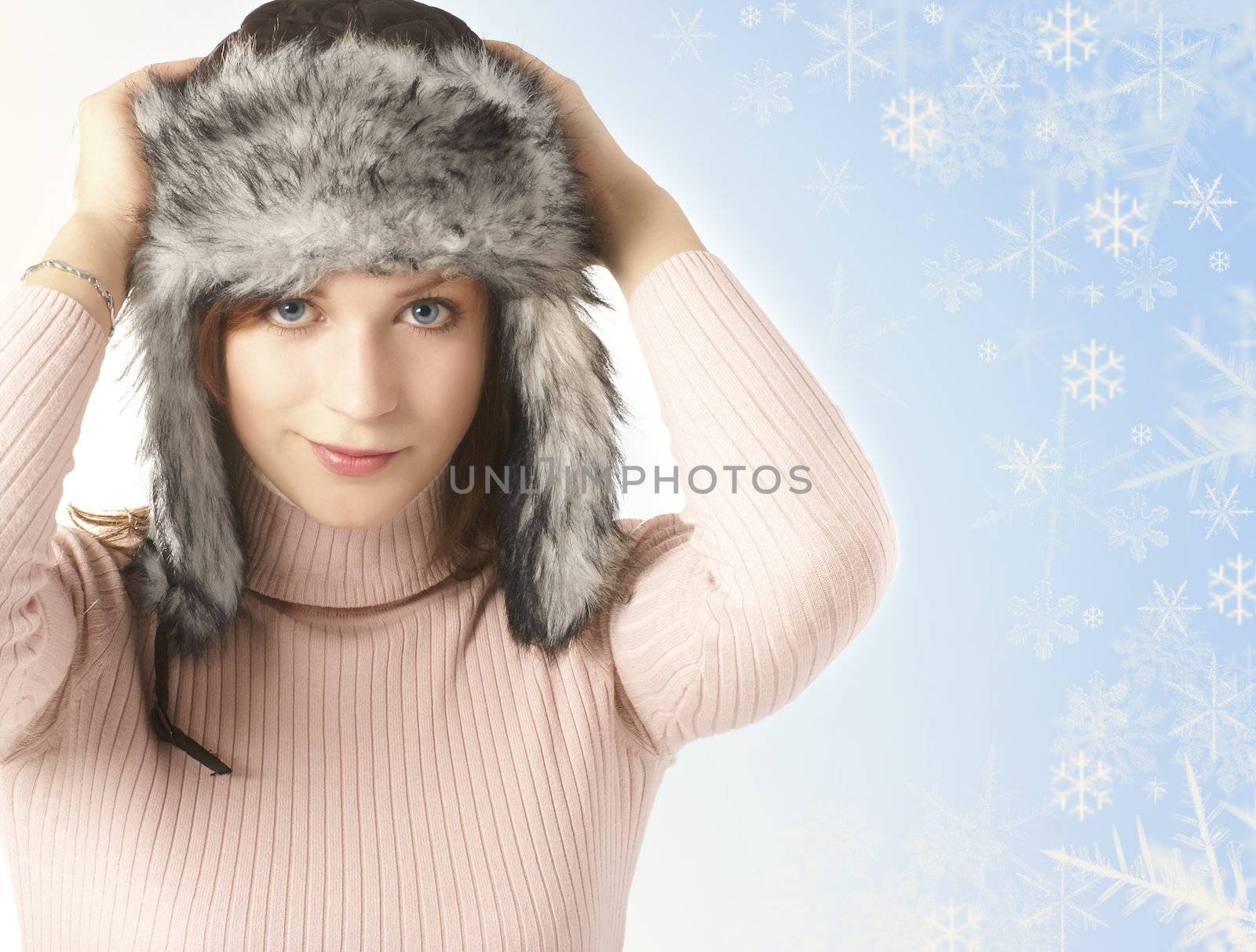 Attractive young woman wearing winter hat  isolated on white