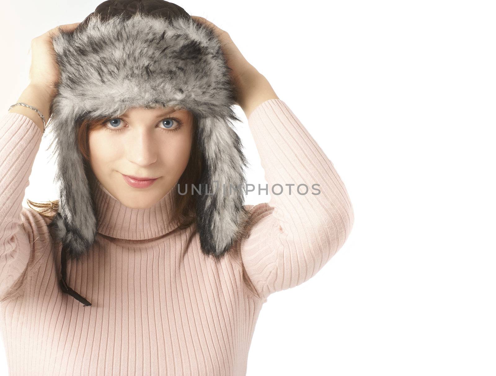 Attractive young woman wearing winter hat  isolated on white