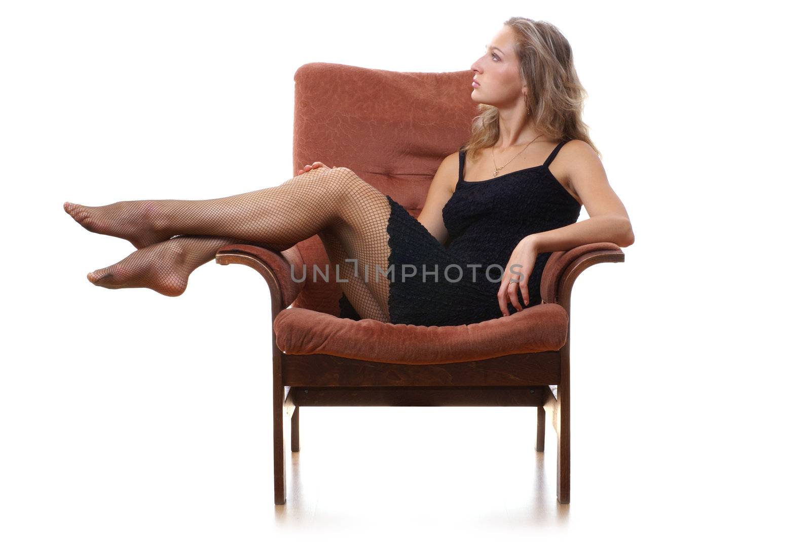 Young lady siting in ancient armchair isolated on white