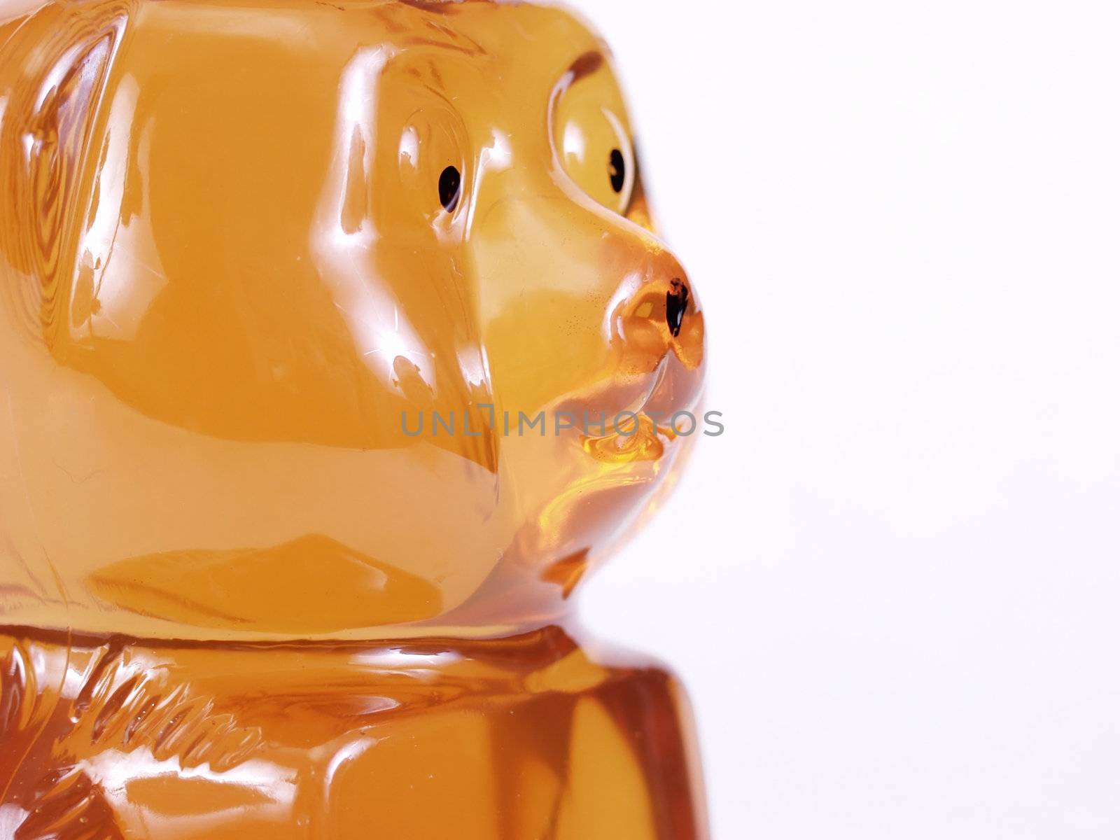 A close up of the face of a Honey bear jar isolated on a white background
