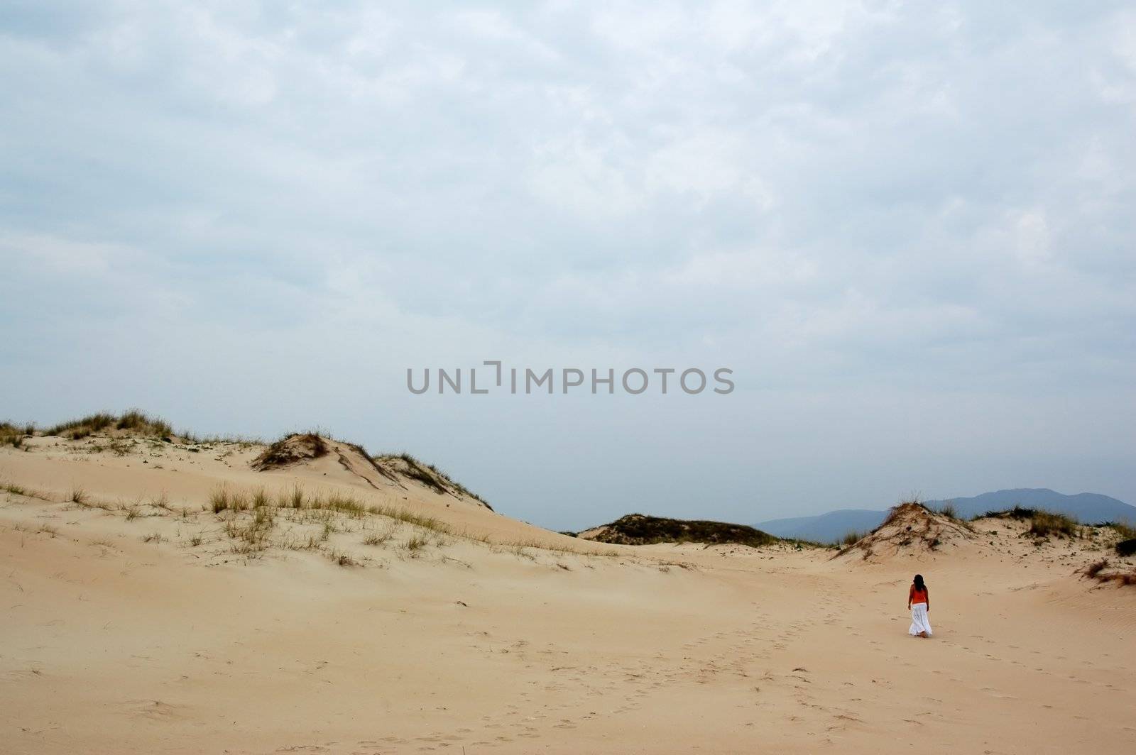 young girl walking on corrubedo dunes by raalves