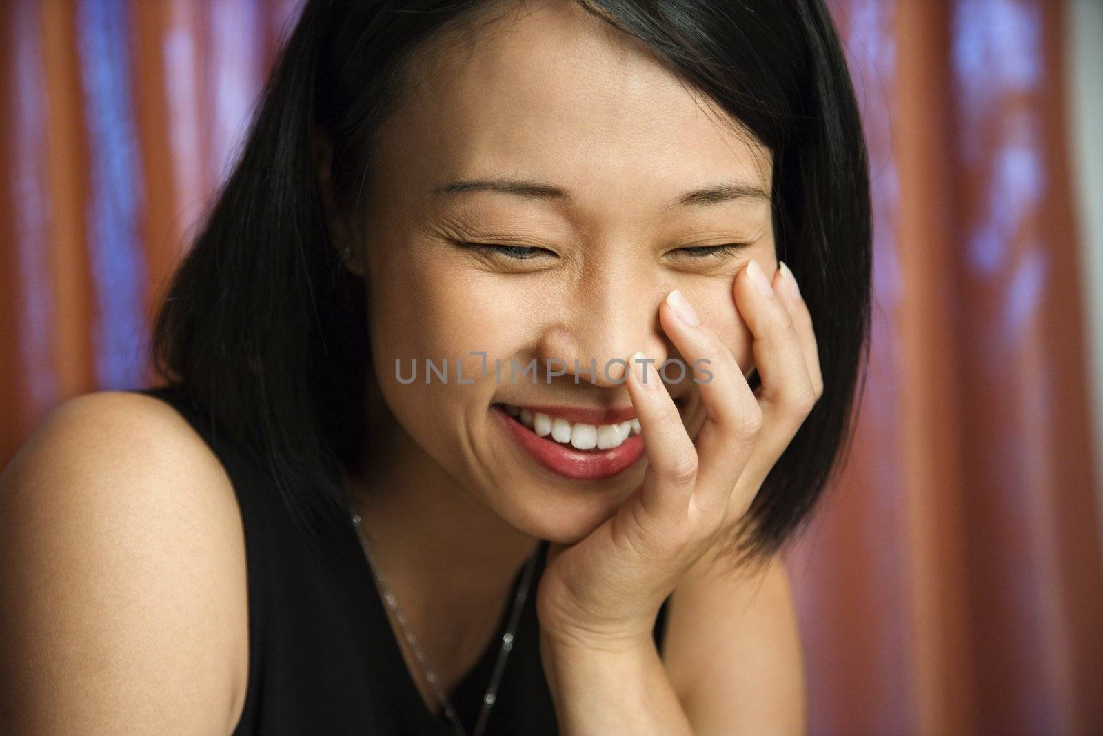 Happy laughing Asian woman. by iofoto