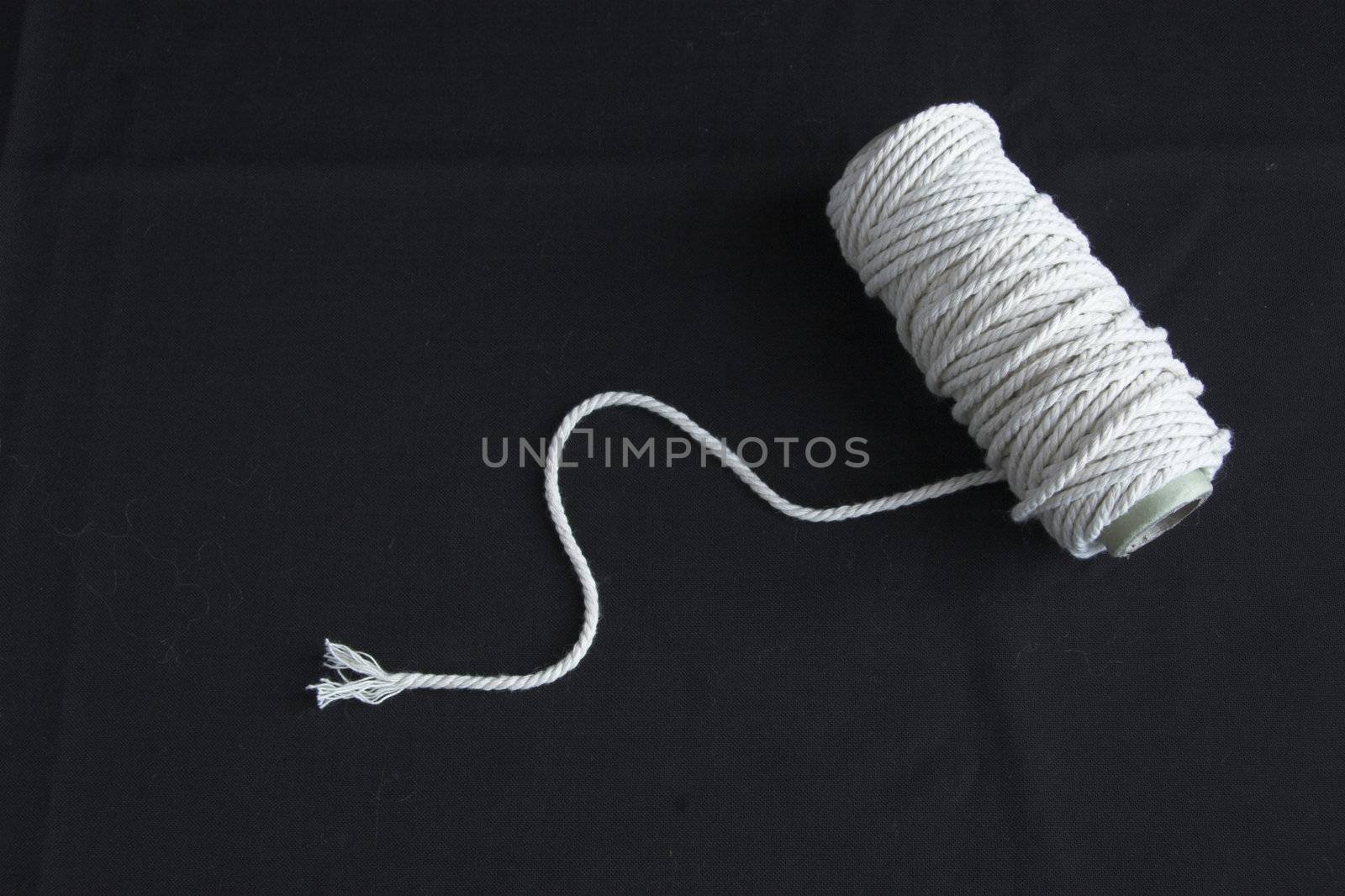 Roll of rope forming spiral on a black background