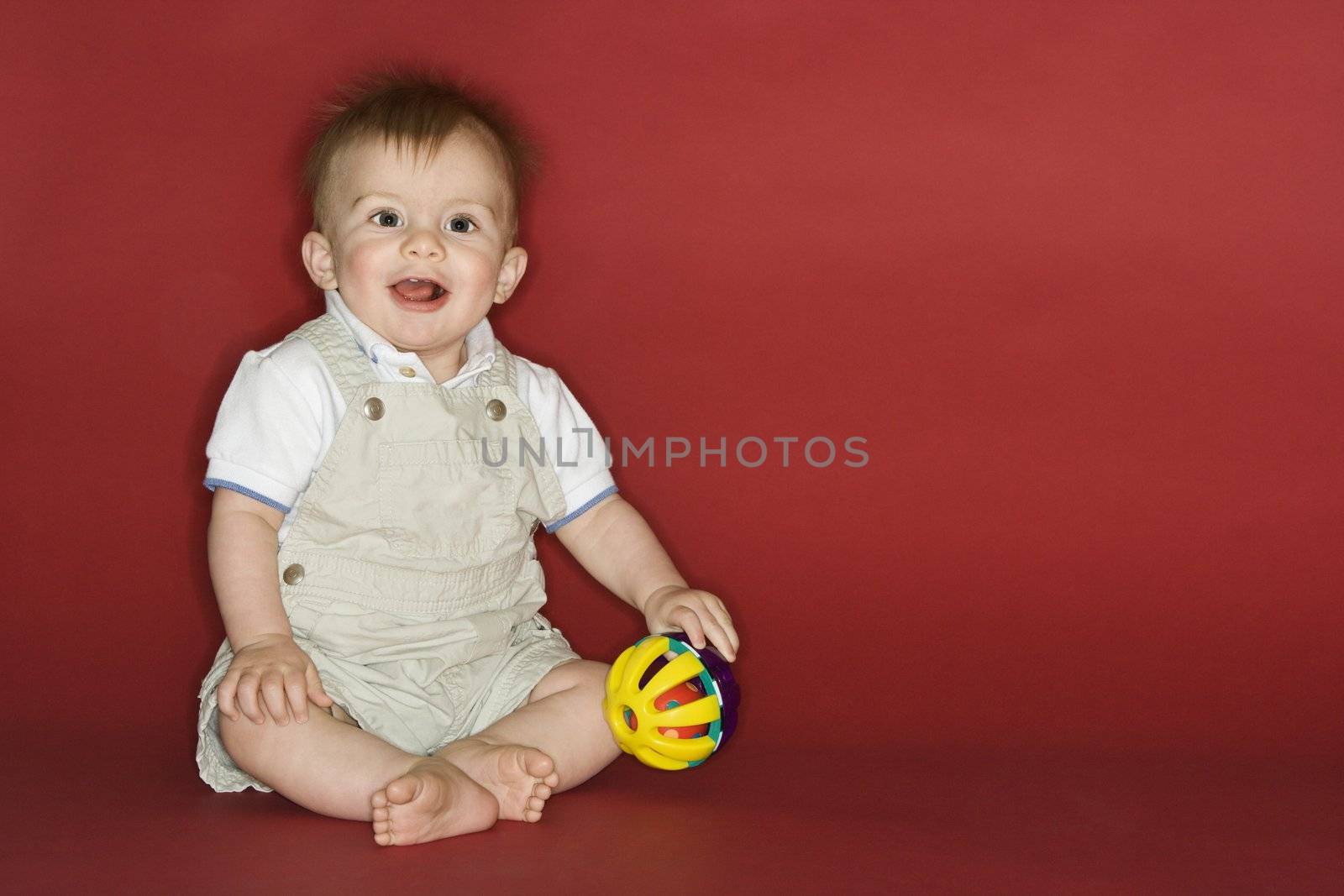 Portrait of Caucasian male child playing with ball.