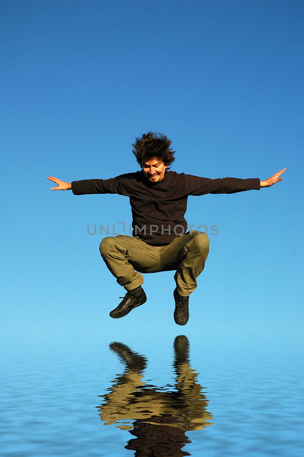 young man jumps, water digitally worked reflection