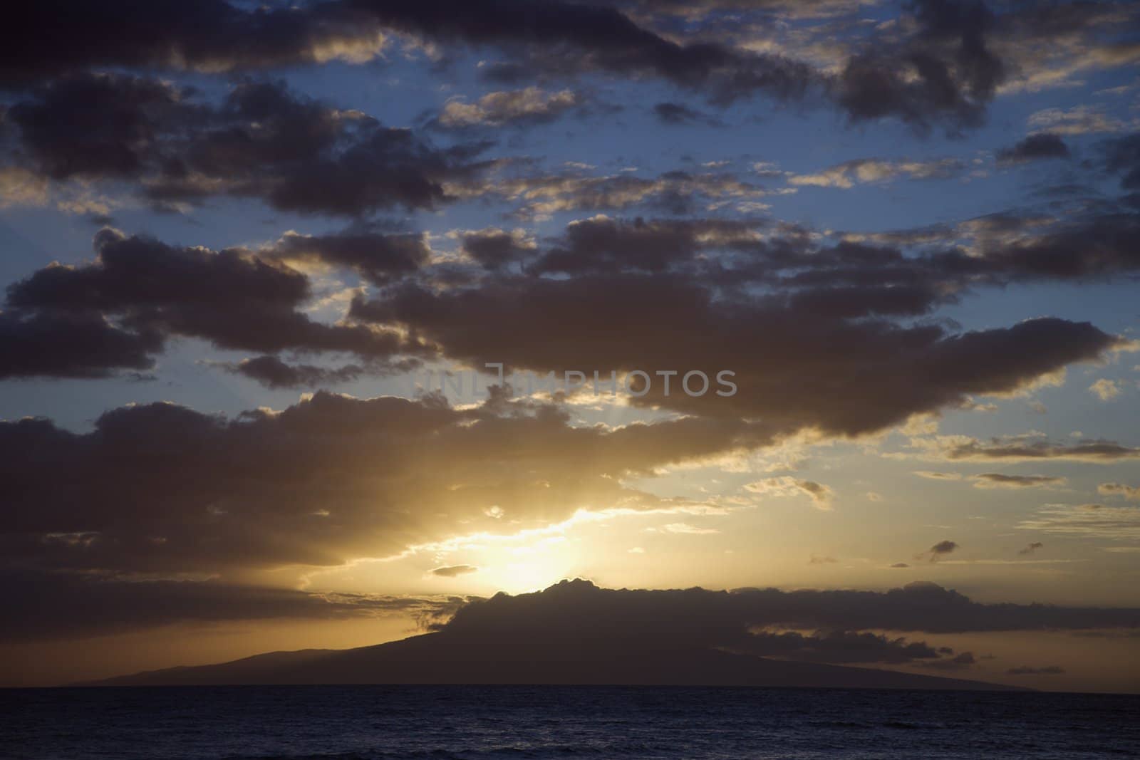 Sunset clouds over coast. by iofoto