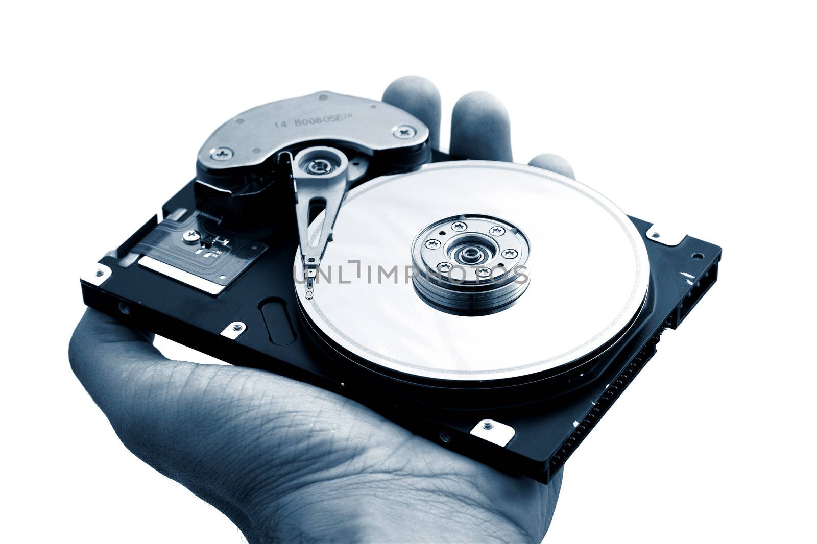 Hand with a open hard disk drive
