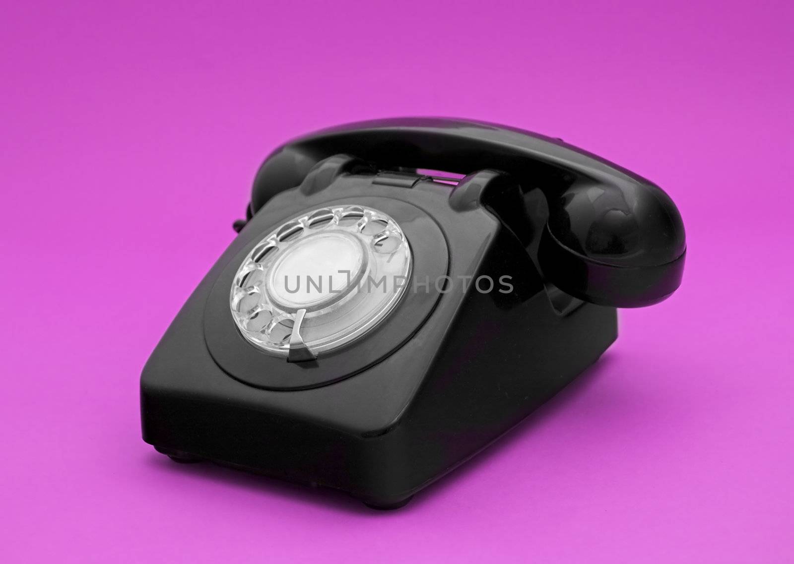 Vintage phone in a pink background