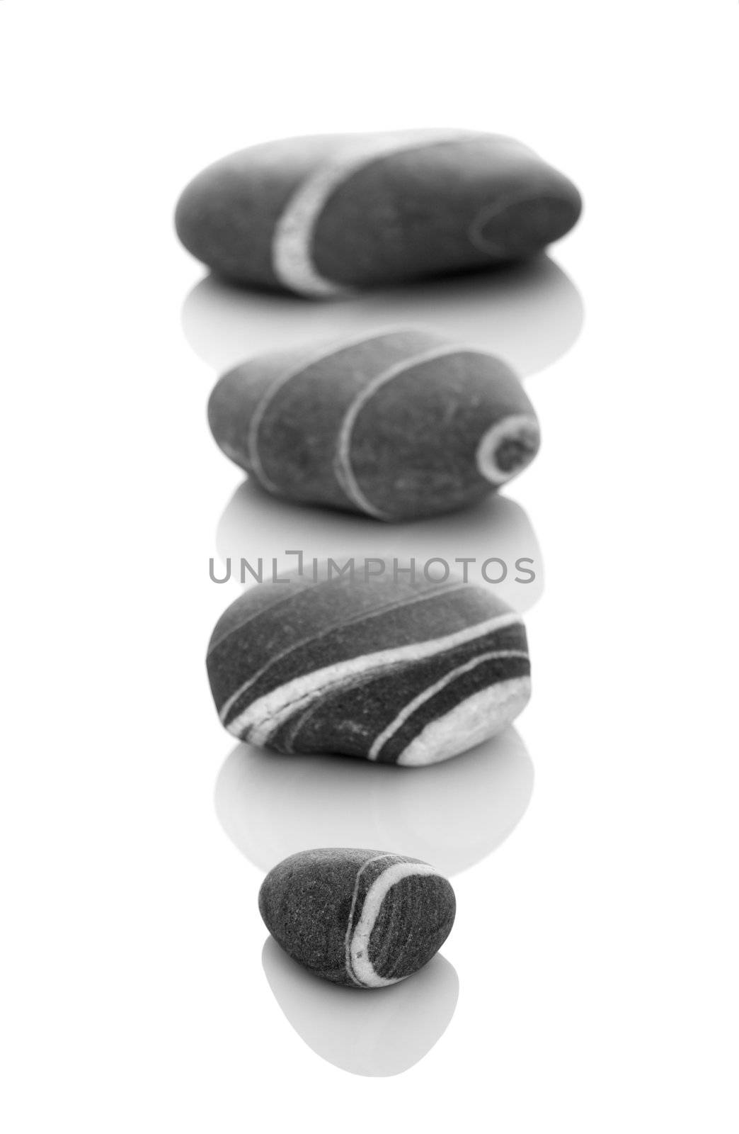 Four stones with diferent sizes in DOF, isolated on a white background