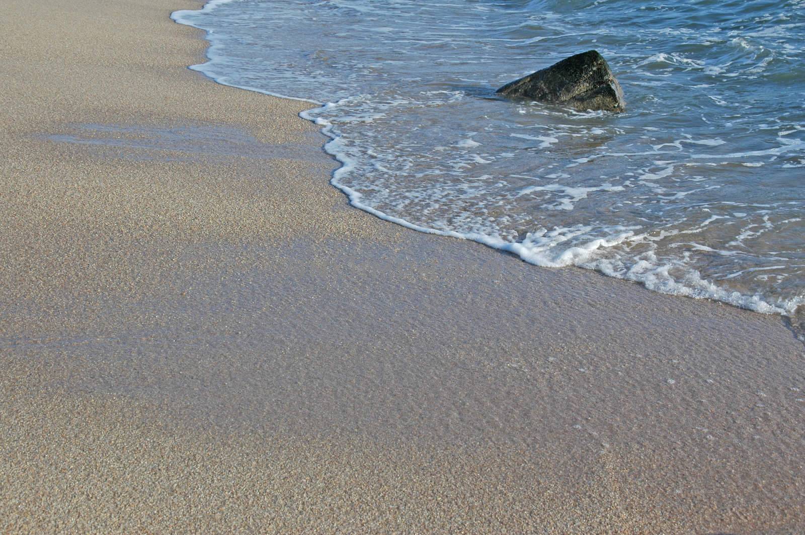 Footprints going over a sand dune