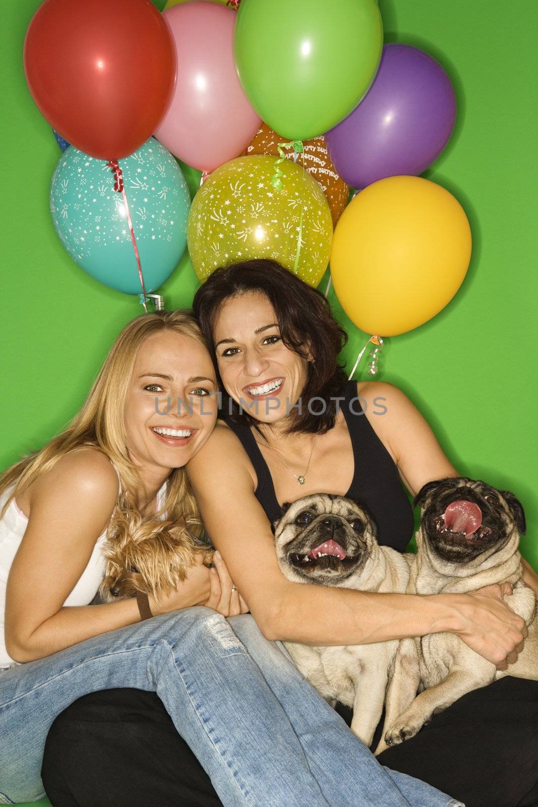 Caucasian prime adult and young adult females with small dogs and festive balloons.